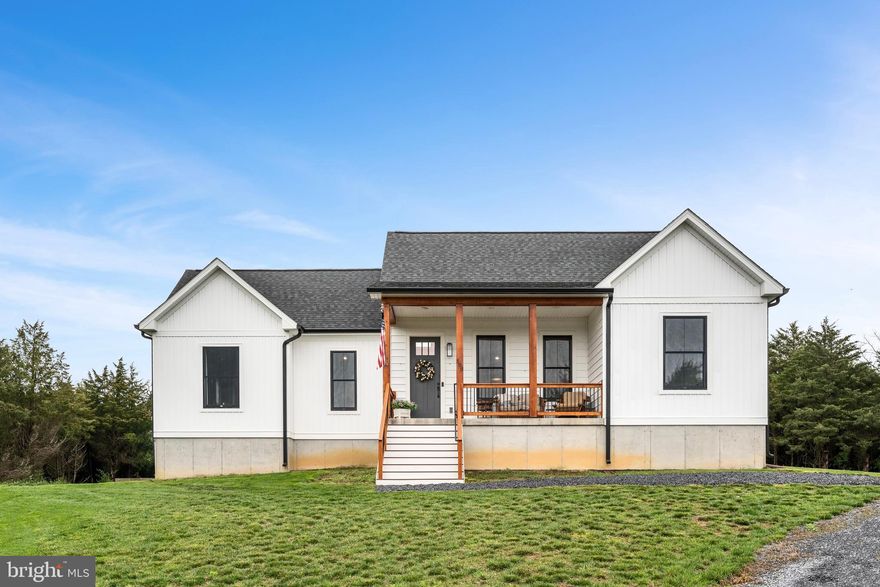 Stunning Custom Modern Farmhouse! This one-of-a-kind home offers single-level living with 3 spacious bedrooms and 2 full baths. The open floor plan boasts soaring cathedral ceilings in the living room, kitchen, and primary suite, creating an airy and inviting atmosphere. The stylish and functional kitchen, features upscale stainless steel appliances, large island with ample seating, soft-close cabinets and drawers. Cozy up by the fireplace wrapped in authentic barnwood, flanked by custom built-ins. The luxurious primary suite offers  double sinks, a jetted tub and walk-in shower for ultimate relaxation. A convenient laundry room adds to the ease of living, while the large unfinished basement provides endless possibilities for future expansion. 

  Unwind after a long day on the large front porch with beautiful cedar posts, or enjoy the rear porch, offering a shaded retreat perfect for grilling, watching wildlife, or sipping your morning coffee or evening wine.   All located on a private lot enclosed with cedars offering year round privacy.  This meticulously crafted home blends modern elegance with rustic charm.—truly a must-see!