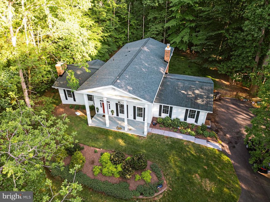 A true forever home. This 5 bed, 3 bath charming Georgian estate sits on over 2 peaceful acres in one of Fairfax Station’s most desirable neighborhoods, Clifton Park. With over 5,000 square feet of living space, the abundance of this home provides flexibility for growing families or multi-generational living, complete with an in law suit on the main level and a massive unfinished basement for tons of storage or the potential to finish and add more bedrooms and bathrooms. The kitchen presents hand scraped hickory wood floors, a custom layered pantry, Cosentino silestone countertops and a full eat in breakfast nook adjacent to an informal family room complete with a beautiful stone fireplace. Upstairs you can find 4 huge bedrooms and 2 updated bathrooms both with dual sink vanities.  Generously setback from the road this property delivers a rolling front yard, fully fenced in backyard, 2 car garage, a balcony off the back of the house and 2 acres of land offering lasting value. Quiet, private, and full of potential—this is where your next chapter begins. Modernizations include a 3 rack Whirlpool dishwasher, kitchen faucet and garbage disposal installed in 2023, 240v 30 Amp outlet suitable for a level 2 electric vehicle charger installed in garage in 2021, newer 85 gallon Pentair water pressure tank for the well installed in 2020, basement egress window installed in 2019, 25-year architectural shingle roof installed in 2018, well pump and pipe installed in 2015 and tons more!