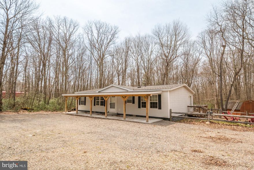 Escape to your own mountain retreat in the beautiful, gated community of Yough Mountain Resort! Situated on a spacious 0.74-acre corner lot, this charming 3-bedroom, 2-bathroom cabin offers the perfect blend of rustic charm and modern comfort. Whether you're looking for a weekend escape or a full-time residence, you'll love the outdoor spaces—enjoy your morning coffee on the covered front patio, host cookouts on the  deck, or gather around the firepit in the expansive yard. The oversized driveway provides plenty of room for guests, trailers, or recreational vehicles, and there's a shed for all your gear. Inside, an open-concept layout connects the kitchen, dining, and living areas. Tucked within the private, recreation-rich Yough Mountain Resort, you'll have access to 50+ miles of ATV, snowmobile, and hiking trails, plus River & Creek access, fishing, and hunting. Deep Creek Lake, Swallow Falls, and the town of Oakland are just minutes away, offering even more to explore. Don’t miss your chance to own this peaceful mountain getaway—where nature, privacy, and adventure come together on one incredible corner lot.