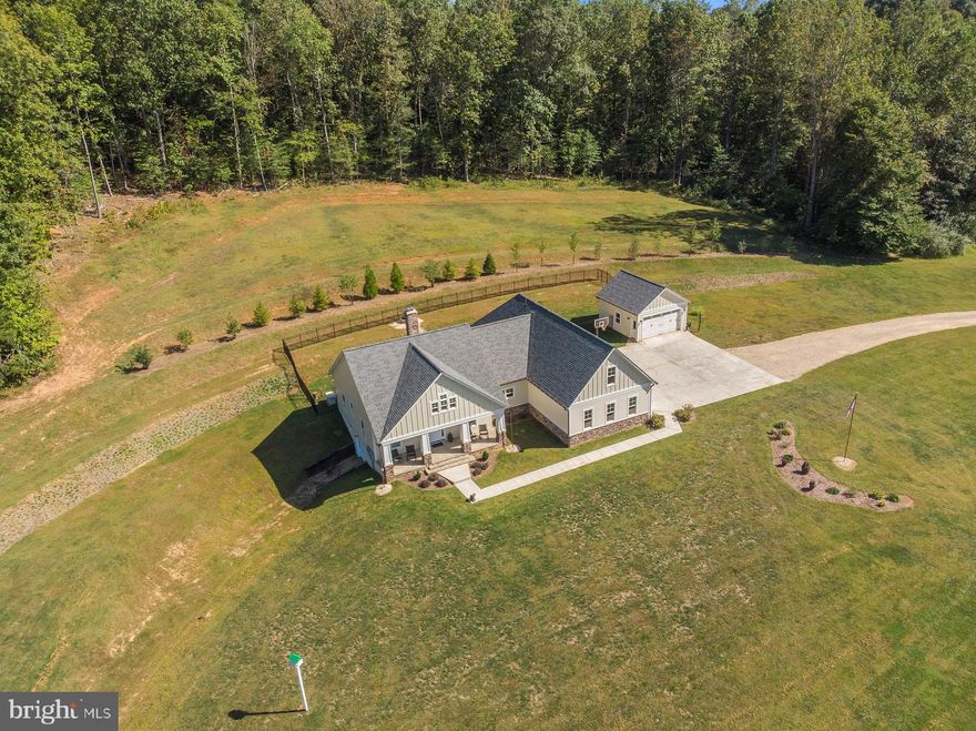 Welcome to 16363 Prosit Lane .this 20 acre parcel is an outdoor lovers dream come true.  Located just 15 minutes from Warrenton and Culpeper, this custom home was built in 2017.  The stone and hardi- plank exterior provide for easy maintenance including large concrete pads to access main house and detached garage with basketball court.  The concrete and stone front porch is extra wide for relaxing, unique gutter chains add a special touch and the view from the porch is perfect for watching wildlife. Inside you will find wide plank pine floors, hickory ship lap accent wall felled from the property, stone wood burning fireplace with stone hearth, open floor plan, vaulted ceilings with wooded beam. Gourmet kitchen with commercial stove, 2 sinks, eat in island, granite counter tops, one of a kind antique pantry door and soft close doors and drawers on the cabinets. Adorable powder room with wine barrel sink sits next to the laundry room with utility sink. Split bedroom plan: Master Bedroom with huge walk in closets.  Master bath has custom tiled rain fall water head plus 2 additional shower heads and  soaking tub plus two vanities.  On the other side of the home you will find 2 additional bedrooms with full bath with granite counter top and tiled shower/tub. The upper level offers a large bedroom with walk in closet and half bath with granite counter top.  Huge 2000 sq ft basement with gym area, recreational room and full bath awaits your vision. The back patio has covered porch leading to hot tub and table space for entertaining. Stone steps carved into the hill lead to fire pit for roasting marshmallows or just relaxing. Tiered yard professionally landscaped with iron fenced yard for the dogs to enjoy the backyard.  For the shooting enthusiast the property offers a pistol and rifle range with  pavilion at range for reloading and preparation. Shed on property is perfect for storing mower and garden tools. The property has some wooded area that provides privacy and a stream that runs year-round.  The remaining acreage is wide open space to allow for all types of outdoor activities including a golf mat & practice hole (located within 5 miles of two golf clubs)  or suitable for horses with some fencing installed.  Come visit this wonderful retreat in Rixeyville. COMCAST INSTALLED!  WHOLE HOUSE GENERATOR!
