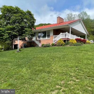 This one is well worth the wait!!! Situated just outside the city limits, it boasts an incredible mountain view that almost seems as though you can see forever and a perfect large composite side deck to appreciate every season. The owner has lovingly and professionally landscaped the property offering many flowering and butterfly attracting plants to also enjoy from your deck as well. Nature lovers will be in their glory watching for the plants and flowers to bloom all season and, if that weren't enough, the 3 bdrm, 1 full and 2 half baths happens to be situated on a double lot (front to back suitable for subdivision with its own street access OR how about a place to build a great detached garage ? There is ample space to do either! There is also a sturdy detached workshop or turn it into she -shed. Can you imagine a happy place like that right in your backyard? There is space to plant a vegetable garden too! So do your inner self a major favor and find the zen you have needed for so long!
The total amount of acreage is for both lots is estimated at .73.
The home itself is warm, inviting, and offers magnificent views from your favorite chair in the living room through totally replaced windows and, no concerns about the roof, a metal one was installed in 2014.
There are two and even possibly 3 sources of heat--the heat pump is very efficient to about 40 degrees and then there is a oil furnace back up. Add to this, at one time there was a wood furnace, however, seller has never used it and may need some work if buyer would desire putting it into working condition (no warranty, though!) Also, downstairs there is a spacious family room with a brick fireplace (owner currently uses a home gym) The laundry room is a great combination of, obviously, the washer and dryer, but also doubles as a very tidy workshop with plenty of spots to store tools, it even boasts of a pull-down ironing board--how convenient--pull you favorite shirt out of the dryer and give it a press! There is a small bath with a shower, again, space the owner never used, however, very convenient if you are working outside and don't want to track through your house! Family room fireplace was never used but could also be converted into gas with some modifications which would certainly be great for a cozy evening with a good movie or game.
Owner says that there are what look to be oak hardwood floors under the carpet!
Just outside the city, on a very quiet dead-end street and near the hospital and many services, this is the house that many are searching for in Allegany County and really worth the wait!!