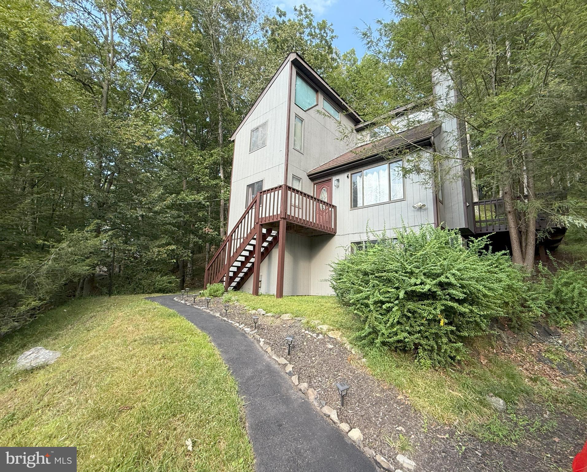 ***PERCHED IN THE TREES*** - This spacious contemporary home captures the essence of the Poconos with abundant natural light and serene wooded surroundings. Offering 3 bedrooms, 3 bathrooms, and many upgrades, this home features a cozy wood-burning fireplace, loft, and office space for work or creativity. The full finished basement includes a convenient walk-out to nature, perfect for enjoying the outdoors right from your door. Public water and sewer add ease to everyday living. Located in a Gold Star Four-Season Community, you'll have access to an incredible array of amenities: indoor/outdoor swimming pools, indoor/outdoor tennis courts, fitness center, 2 ski trails (with snowmaking), beach area, fishing dock, pedal boats, rowboats, racquetball court, basketball court, baseball field, playgrounds, ice skating, and a full-service restaurant and bar. Don't miss your chance to own this mountain retreat-schedule your private viewing today!