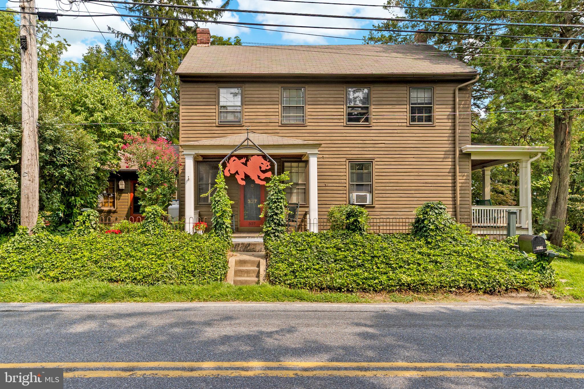 History, charm and opportunity come together in the most delightful way only here at 327 E Street Road in picturesque Kennett Square. Nestled on just about 1 acre of storybook grounds, this one-of-a-kind property has worn many hats over its 200+ years; once a general store and post office, a stop on the Underground Railroad, an AT&T substation, and now a cherished private residence. This is not just a home, welcome to a local landmark rich with history and love. The main house offers nearly 2,000 square feet of character-filled living space, with a separate basement entrance off E Doe Run Road which allows for convenience and additional parking. The opportunities are endless here with 3 spacious bedrooms, 2 full bathrooms, and multiple entrances and living spaces. A separate barn area allows for a versatile outbuilding perfect for hosting gatherings, working on creative projects or simply enjoying time with loved ones. The exterior is just as impressive as the interior as the property provides a peaceful escape with blooming perennial gardens, a wooded corner for exploring, and a fully fenced backyard—ideal for pets, play, or quiet relaxation. The front yard encompasses a gorgeous perennial garden filled with irises, allium, columbine, phlox and daffodils. Flowering trees along the property include a Chinese Magnolia, Japanese Maple and Dogwood. Each season offers its spectacular beauty through nature in each part of the yard. If you are searching for a home that tells a story and invites you to write the next chapter, 327 E Street Road is ready to welcome you.
