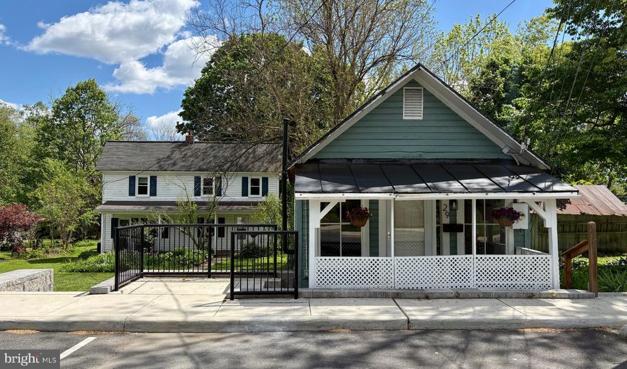 Unique opportunity to own a piece of Round Hill/Loudoun Rail Road history that offers TWO separate homes on one parcel.  Plenty of character AND income generating potential! Both homes have served as income generating rentals and are eligible for short term/AirBnB use. Set back off the road, the main/farmhouse (#31) was built in appx 1908 and once served as the bunkhouse for the Round Hill station on the Washington & Old Dominion line.  The two-story home offers  a charming front porch, original wood floors on much of the main level, a modernized kitchen, main floor bedroom and a full bath, as well as three more bedrooms upstairs.  The farmhouse has a newer HVAC (2025), Stove (2025), Washer & Dryer (2018), Fridge, Dishwasher, & Microwave (2015). Other major systems have been maintained/replaced in recent years - Hot Water Heater (2010), Roof (2005), Windows (2005)

The smaller "cottage" (#29) was believed to have been built in the 1920's and served as the Round Hill General Store for a period of time.  It has since been converted to a cozy one bedroom/one bath home  that was recently used as an income generating rental property.  The living area features the original wood floors. Updates/Maintenance include: Roof Resurfaced (2023), Hot Water Heater (2022), Windows (2022), Stacked Washer/Dryer (2022), Baseboard Heat Installed (2018), Fridge (2017)

Both are on public water/sewer and share utilities. There are 3 parking spaces on street in front of the homes. Please note - property is being sold "as-is" and listing "details" refer to the property at 31 Main St (4 beds, 1 bath, 1416 sq ft.) and 29 Main St provides another 1 bed, 1 bath, 450 sq ft.