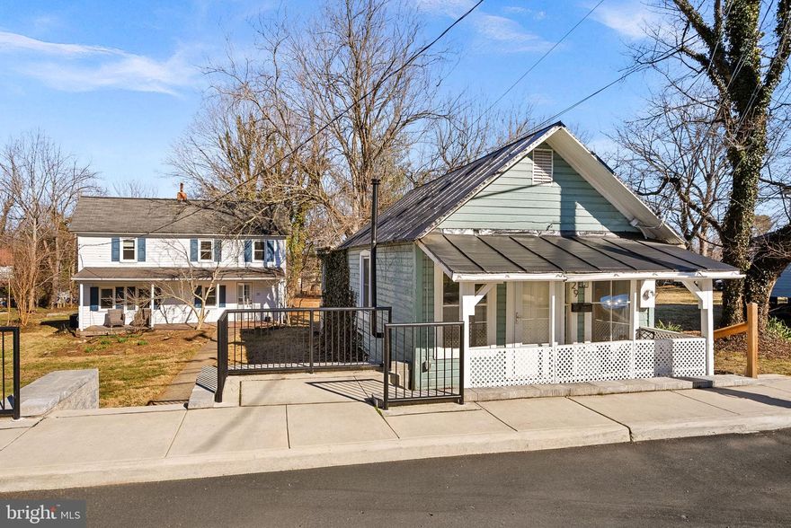 Unique opportunity to own a piece of Round Hill/Loudoun Rail Road history that offers TWO separate homes on one parcel.  Plenty of character AND potential! Set back off the road, the main/farmhouse (#31) was built in appx 1908 and once served as the bunkhouse for the Round Hill station on the Washington & Old Dominion line.  The two-story home offers  a charming front porch, original wood floors on much of the main level, a modernized kitchen, main floor bedroom and a full bath, as well as three more bedrooms upstairs.  The farmhouse has a newer HVAC (2025), Stove (2025), Washer & Dryer (2018), Fridge, Dishwasher, & Microwave (2015). Other major systems have been maintained/replaced in recent years - Hot Water Heater (2010), Roof (2005), Windows (2005)

The smaller "cottage" (#29) was believed to have been built in the 1920's and served as the Round Hill General Store for a period of time.  It has since been converted to a cozy one bedroom/one bath home  that was recently used as an income generating rental property.  The living area features the original wood floors. Updates/Maintenance include: Roof Resurfaced (2023), Hot Water Heater (2022), Windows (2022), Stacked Washer/Dryer (2022), Baseboard Heat Installed (2018), Fridge (2017)

Both homes are on public water/sewer and share utilities. There are 3 parking spaces on street in front of the homes. Please note - property is being sold "as-is" and listing "details" refer to the property at 31 Main St (4 beds, 1 bath, 1416 sq ft.) and 29 Main St provides another 1 bed, 1 bath, 450 sq ft.
