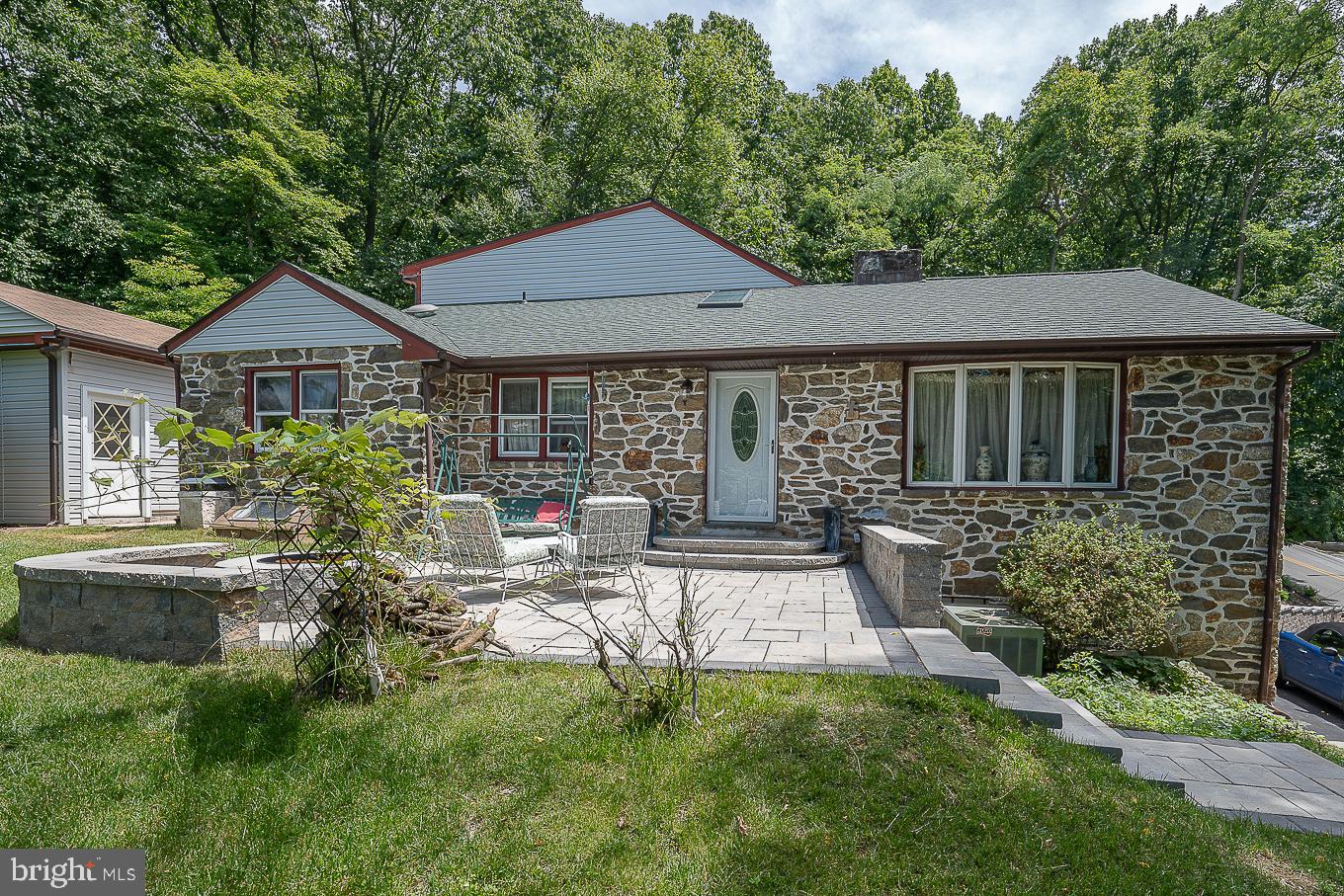 446 Irish Road is a great combination of a modern home in a natural setting. Vistas of nature greet your from all sides. Nestled into the hillside this expanded stone ranch is a mix of modern and traditional all in one! Remodeled in the 90s with a gourmet kitchen featuring Corian countertops, a huge island with kitchen space sufficient for hosting large gatherings of friends and family. The kitchen area opens to a formal dining room and great room with vaulted ceiling, and stone fireplace. This home is a great mix of indoor spaciousness and outdoor access leading to multiple decks. You can enter or exit the house on any of the three levels via deck or lawn. Privacy – flow – and energy capture the spirit 446 Irish. This home is not your typical ranch – frankly not your typical home at all. It has many of the modern tweaks you desire and has built with good old building methods including hardwood floors throughout. You have two zone HVAC as well. There is a finished walk out basement with large mudroom, laundry area, office and plenty of storage space. The attached one car garage is accessed from the lower level as well. From 446 you can walk to Hillside Elementary School – and you are in the Tredyffrin-Easttown school district. This marvelous Berwyn home has location, location, location and style.