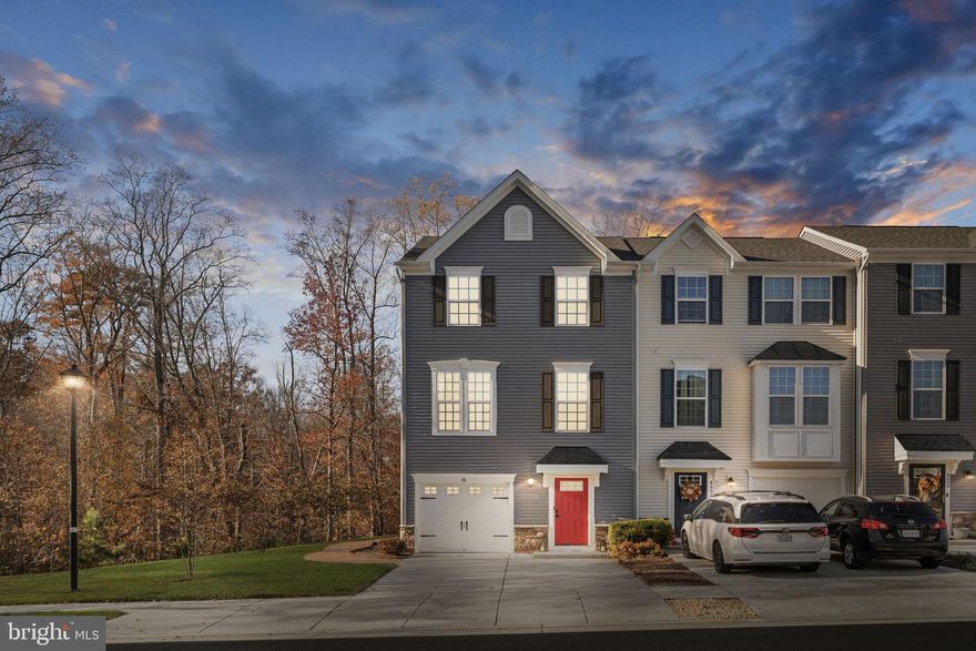 Welcome to 8600 Wilmore Lane, an immaculate end-unit townhome loaded with upgrades and thoughtfully designed spaces throughout. The entry level features a spacious bedroom or recreation room complete with a private full bath, dual walk-in closets, and its own walk-out entrance leading to a rear patio and a charming wraparound walkway.

The open-concept main level boasts gorgeous wood floors, a stunning center island kitchen with granite countertops, pendant lighting, and ample seating. Enjoy generous dining and living areas, an additional powder room, and access to the composite deck with vinyl railing—perfect for grilling, relaxing, or entertaining with serene, tree-lined views.

Upstairs, the home offers a luxurious primary suite featuring a walk-in closet and an attached bath with a dual vanity, separate shower, and a deep soaking tub. Two additional well-sized bedrooms, another full bath, and a dedicated laundry area with convenient storage cabinetry complete the upper level.

Additional highlights include a one-car garage plus a driveway accommodating up to two more vehicles.

Located in the desirable Village at Courthouse Commons, residents enjoy fantastic community amenities such as a swimming pool, playground, sidewalks, and exterior maintenance—including gutter cleaning, power washing, and yard care—handled for you.

This exceptional property offers comfort, convenience, and style in an unbeatable location—don’t miss it!