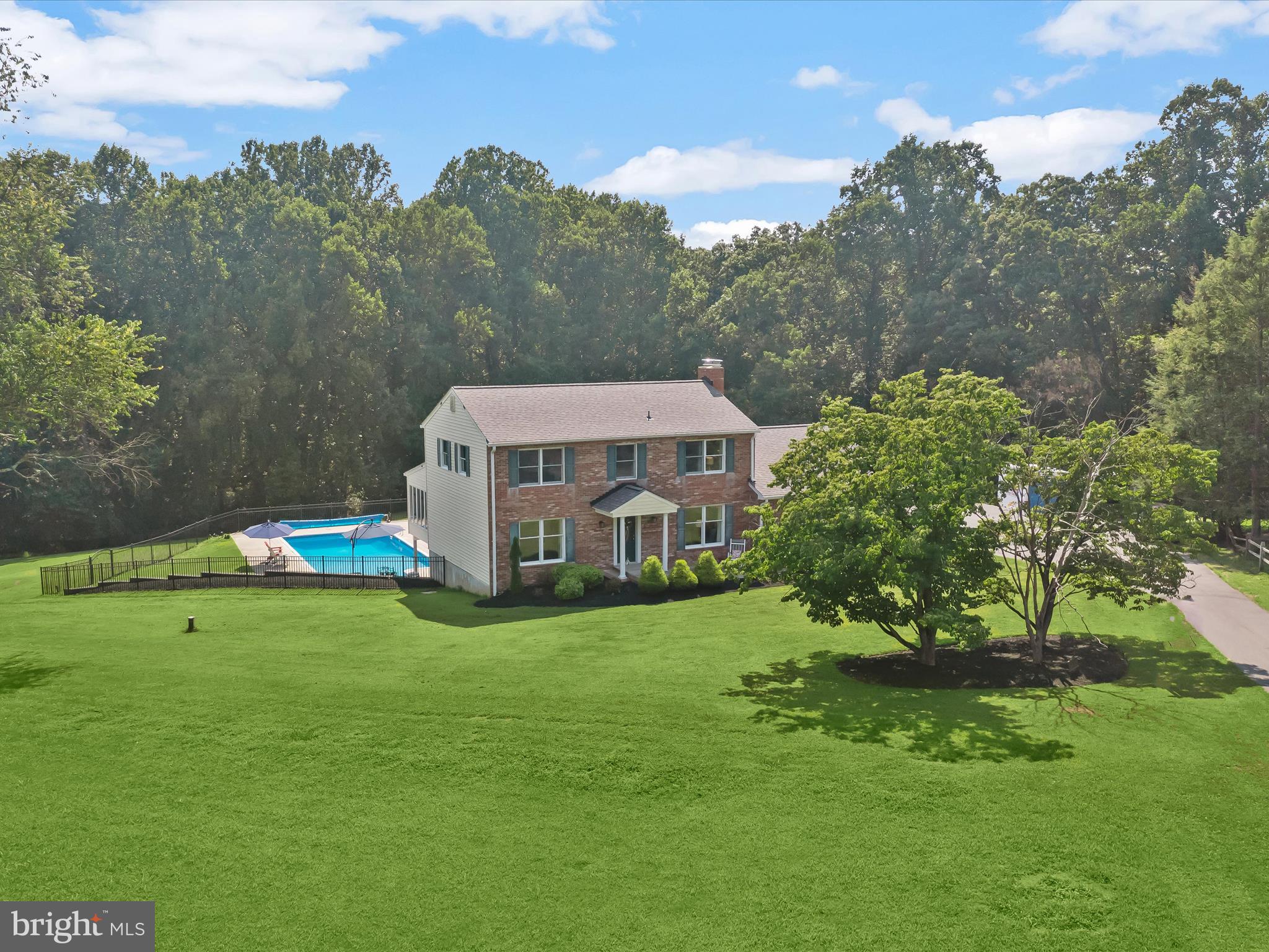 Private Oasis on Nearly 4 Acres with Pool & Energy Efficiency Upgrades
Nestled on nearly four acres of lush, wooded privacy, this exceptional 5-bedroom, 3.5-bath custom home offers the perfect blend of tranquility, modern comfort, and resort-style living. Set back privately from the road, this stunning property welcomes you with charming curb appeal, expansive front and side lawns, a covered front porch, and a side-loading two-car garage.
Inside, natural light fills the inviting living spaces, which feature luxury vinyl plank flooring and two wood-burning fireplaces. The upgraded central kitchen is designed for both everyday living and effortless entertainment, with rich wood cabinetry, coffee bar, pantry closet, breakfast bar, and seamless flow to the living room, dining room, family room and expansive sunroom. The stunning four-season sunroom, with plush carpeting, atrium doors, and remote-controlled shades, opens to a low-maintenance composite deck and offers panoramic views of the wooded backyard retreat.
A main-level bedroom with full bath and a private side entrance provides flexible living options, ideal for guests or accessibility needs. Upstairs, the serene primary suite features upgraded carpet, a walk-in closet with pocket door, and an updated en-suite bath with a walk-in shower and frameless glass door. Three additional spacious bedrooms and a beautifully remodeled hall bath with dual vanities complete the upper level.
The fully finished lower level with a daylight walk-out slider door is perfect for recreation, with a massive gathering space, wet bar, and easy access to the patio and pool area. Family and friends will meander outside to enjoy a 20’ x 40’ in-ground pool with an upgraded liner, bubble cover, and full fencing—perfect for relaxing summers or entertaining guests under the sun or in the shade of the covered lower patio. Additional outdoor features include a low maintenance rear dining deck, stone garden beds, and a lower storage garage.
Recent upgrades include a new roof (2023), high-efficiency washer and dryer, new HVAC, water heater, and a fully integrated geothermal system assisted by solar panels—providing outstanding energy efficiency, sustainability and low-cost resort style living.
Whether you're seeking peaceful daily living, room to roam, or the ultimate summer gathering spot, this one-of-a-kind property delivers it all—and more.