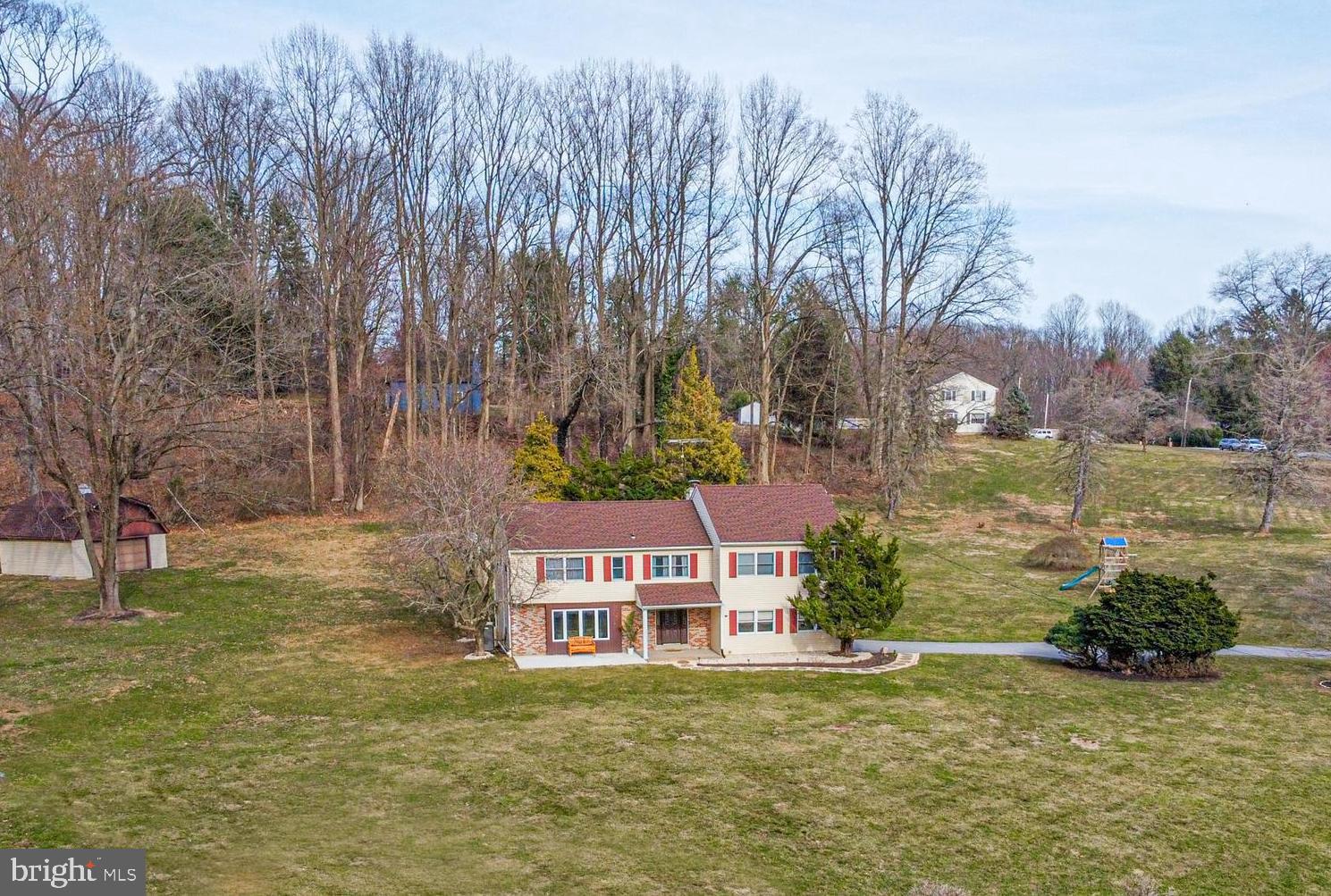 A rare find, this 2900+ square feet, 5 bedrooms, 3.1 bath home is located on 2.15 acres with a pool! The living room flows into the dining room, which completely opens to the kitchen, making this a very usable space. The updated kitchen features off-white cabinetry with granite countertops, a beautiful tile backsplash, and stainless steel appliances. The cozy sitting room/study with a fireplace, built-in bookshelves, and wood paneling has so much character! From here, you will find sliding glass doors to the sunroom.  A very spacious family room with sliding doors to the outside offers a bright and sunny gathering space. A powder room completes the first floor. Upstairs you will find an expansive master suite with a vaulted ceiling, a sitting area, and a full bath. Renovated in 2020, the hall bath offers a double vanity and on-trend finishes. 3 bedrooms share this hall bath, and another bedroom features an ensuite bathroom. This could easily be used as a second master suite. This home also has a detached garage, which could also be used as a workshop. The private pool and large backyard make this the perfect outdoor oasis. These homeowners have meticulously updated and maintained this home. It is immaculate and move-in ready! Home was previously withdrawn from the market because sellers had not yet identified a new home. Now back on the market because sellers are ready to move!