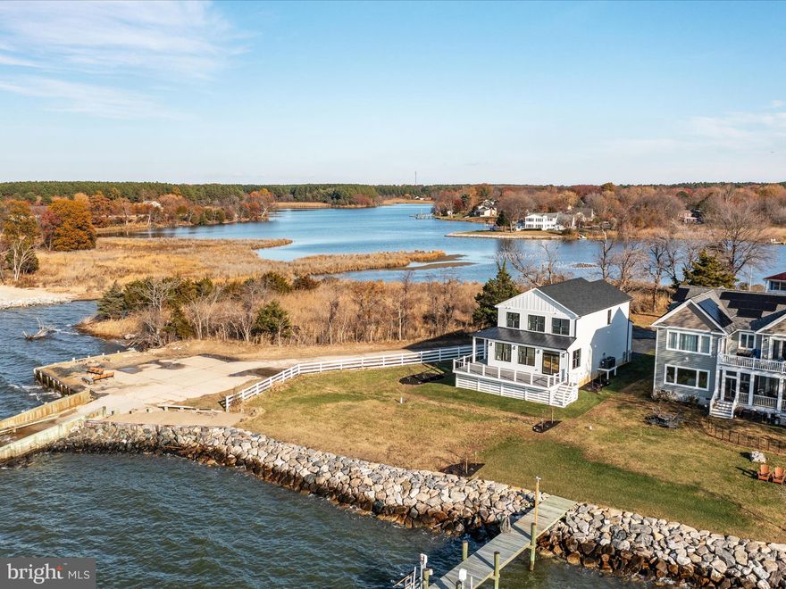Gorgeous Chesapeake Bayfront Coastal Farmhouse!   Enjoy the most serene sunsets every night from your back deck or covered wrap-around porch.  Elevated homesite with new riprap along the water's edge.  This new home features hardiplank siding with stone veneer garage front, oversized garage door, wrap around composite porch/deck with stainless steel cable rails, and a low-maintenance exterior!  

Inside the home, modern farmhouse meets coastal living with beautiful finishes that make this home completely turn-key!  Gas fireplace in the family room with shiplap trim, solid wood floors, LED overhead lighting, Craftsman style trim and casing, a modern kitchen that opens to the main living space, custom steel railings, and the list just goes on and on.  The waterviews are so impressive, you'll feel like you're on a cruise ship!  The first floor also features a walk in pantry with custom built ins and powder room.

The second floor master suite will blow your mind with the incredible water views and sunsets!  Enjoy the water views even while you're in the shower!!!  Wood floors run through the upstairs hallway and into the two additional bedrooms, both featuring water views.  The full baths  feature tile floors as well as tile surrounds for an elevated feel.  Ceiling fans and designer lights are already installed!