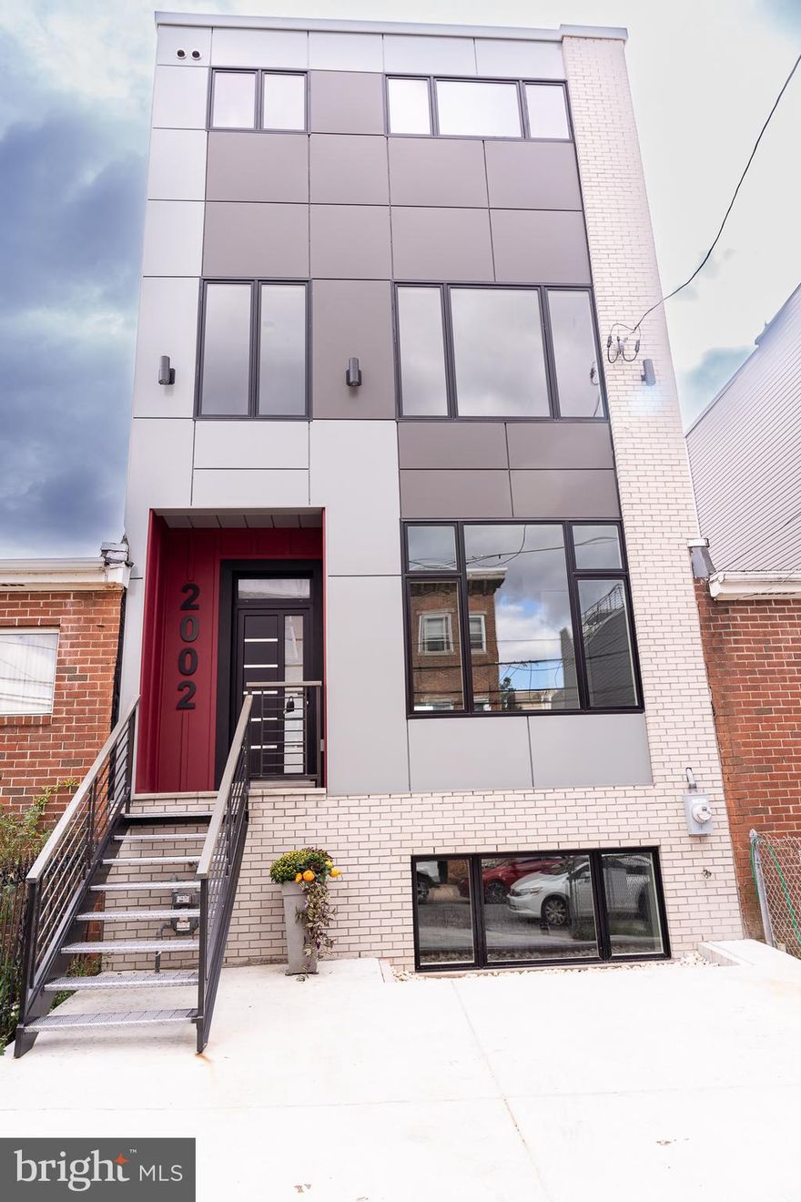 This house should be at the top of your list.
Introducing the Jewel of Fairmount - your dream 4-bed, 4.5-bath, with a den, 3,460 sq. ft. townhouse in the Fairmount area, with parking suitable for two cars on a tranquil tree-lined street. The house has been designed by one of the best designers in the city. 
As you enter the house, you'll find the heart of the home - an open-concept of living, dining, and kitchen area with a 10-foot-high ceiling, elegant moldings, a modern electrical fireplace, and abundant natural light from beautiful large windows. The state-of-the-art gourmet kitchen features quartz countertops, a unique tile backsplash and a spacious waterfall kitchen island under the pendant lights.  The island includes a built-in wine refrigerator, microwave, extra cabinets and serves as the centerpiece, inviting both culinary creativity and social interaction. The kitchen also comes with high-end stainless steel Samsung appliances and floor-to-ceiling two-tone cabinetry with under-cabinet lighting.
The second level hosts two spacious bedrooms with generous walk-in closets and en-suite bathrooms. There's also a versatile room suitable for a home office or kid’s room, plus a convenient laundry room with a full-size Samsung front load washer, dryer, and a laundry sink. The North-facing bedroom features a tub-equipped bathroom, while the South-facing bedroom boasts a large shower. All bathrooms are elegantly tiled and equipped with modern plumbing fixtures, lighting, and accessories.
The third floor contains the unique master suite that spans the entire level, featuring a great master bedroom, oversized walk-in closets, and the luxury en-suite bathroom. The bathroom has a walk-in shower with marble bench and waterfall shower head, dual vanity, two pantries, modern soaking tub, designer tiles on the floor and walls adorned with Carrara marble accents along with high-end plumbing and lighting fixtures. A convenient powder room for the roof deck visitors concludes this floor.
The raised basement floor offers an additional suite with a large family area, bedroom, and a full bathroom with a tub. Abundant natural light floods in through large windows facing both the south and north. 
This house boasts top-tier finishes like solid maple flooring, custom open-riser staircases, and contemporary lighting and plumbing fixtures. Also, the house contains a tankless water heater, dual zoned HVAC system and much more. 
Finally, ascend to the panoramic rooftop deck with glass surroundings, boasting breathtaking 360-degree city views - a perfect spot for entertaining guests. The roof deck has a pedestal system that provides you with a flat walkable surface. There are gas, sewer, hot and cold water, and electricity hookups on the roof deck, offering the option for a full kitchen setup. And the cherry on top of the cake, both South-facing bedrooms on the second and third floors have incredible priceless city view.
With a prime location within walking distance of the Fairmount commercial corridor, Art Museum, and Center City, this home is a walker's paradise.
There is a tax abatement approved for the property , it was approved prior to changing the law. 
Owner is a Realtor.