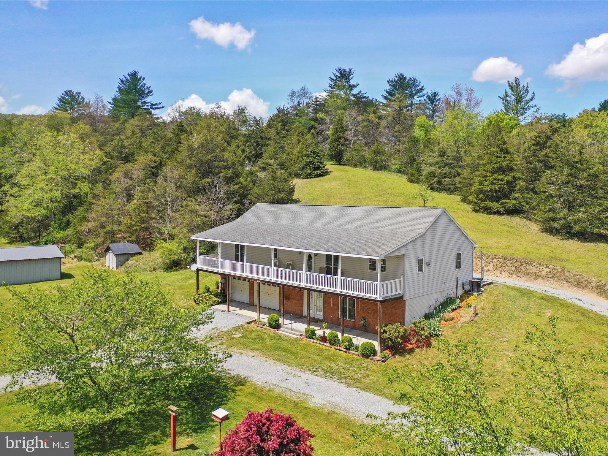 Don’t miss this unique opportunity to own a stunning 3-bedroom, 3-bathroom home nestled on 24.81 unrestricted acres of beautifully diverse land. Whether you're seeking a peaceful retreat or a multifunctional property with income potential, this one checks all the boxes. Step inside to discover gleaming wood floors and a gourmet custom kitchen perfect for the home chef. The main level offers on-level living with a large laundry area, two spacious bedrooms, including a luxurious primary suite featuring a large ensuite bathroom and a generous walk-in closet. The home is also plumbed for an additional half bath, offering potential for expansion. The living room is spacious and ideal for entertaining, while the finished lower level provides flexible living space with a game room, full bathroom, utility room, and a room previously used as an in-home hair studio—easily converted into a mini kitchen. There’s also an additional room used as a bedroom and a private entrance through the attached two-car garage. Enjoy double porches on the front and scenic outdoor spaces on two sides of the home—perfect for taking in breathtaking mountain views. The property also features a detached one-car garage, a well-maintained cellar ideal for storage or canned goods, and open land currently used for hay production. You'll also find wooded acreage with two hunting blinds. As an added bonus, there's a rental home on the property providing additional income potential. Located just 30 minutes to Broadway, VA, under 30 minutes to Wardensville, WV, and only 10 minutes to Lost River State Park, with a pizza shop and gym just 5 minutes away—this home is perfectly positioned for both seclusion and convenience. This is a one-of-a-kind property you won’t want to leave—schedule your showing today!