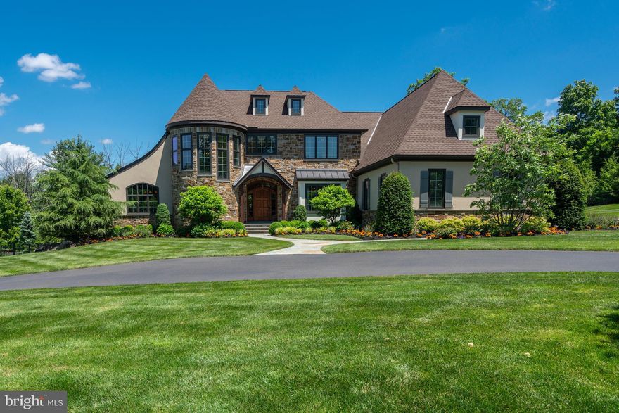 Welcome to one of Gwynedd Valley’s finest estate homes. Once our sellers completed their search for the perfect lot to build their custom retreat, they teamed up with noted architect Rene Hoffman, designer Allison Forbes and the area's premier builder Guidi Homes to create one of the area's finest custom homes. No detail was overlooked in the execution; with the goal of building the perfect retreat designed with family, entertaining and easy everyday living in mind. Tucked away in The Estates of Gypsy Hill, you are met by the sweeping governor’s driveway, meticulous landscaping and a beautiful front entrance. Upon entering the home, you are immediately struck by the abundance of natural light from the sweeping custom grand stair, the spacious open floor plan, and the front to back design. The foyer flows into the adjoining open dining room and large two-story great room accented by multiple Juliet balconies, custom wood beams, custom light fixture, a cut stone fireplace and stone accents. The large custom kitchen is a chef's delight and offers plenty of room to work and entertain with a large center island, high-end appliances, including a large six burner Wolf stove with double oven and griddle, Sub-Zero and wall oven and microwave, and a second counter space between the kitchen and great room offers additional seating. The large morning room offers access to the rear covered porch and views of the pool and rear entertainment spaces. In between the kitchen and dining room is the large custom butler’s pantry with ice maker, ample storage, custom sink, domed ceiling and custom lighting. The rear family entrance offers access from the extra-large three car garage and has a small work station, powder room and a large laundry room. Just off the foyer is a second guest powder room, 3-stop elevator and beautiful home office with coffered ceiling and custom wainscoting. The first-floor primary bedroom is the owners retreat, with an extra high tray ceiling and private access to the rear covered porch and pool area. The owner’s large marble spa bath has a double walk-in shower, soaking tub and custom double vanities. There are two well-appointed walk-in closets just off the owner’s bath. Take the elevator or the grand sweeping stair to the second-floor lounge with wet bar, small refrigerator and custom cabinets. The second-floor lounge and main hall overlook the great room from three beautiful Juliet balconies. The first guest suite has direct access to a large bath with double vanity and access to the hall. There are two additional bedroom suites, each with a private bath, a large walk-in closet for additional seasonal storage, and a large fourth bedroom - currently used as the bunkhouse. The daylight lower level is an entertainer's dream with a large family room, extra-large bar with two beverage refrigerators, wine storage, ice maker, dishwasher, and sink; a billiards room, private gym, game room, dining area, private changing room and cabana bath. Walking out the lower level there is a lower patio with a fire pit and sitting wall, perfect for a nighttime cigar. Just off the kitchen, great room and primary bedroom is the covered porch with heat lamps and steps to the large upper patio with outdoor fireplace and grill area with a Wolf grill, sink and storage. The pool level offers additional seating areas, pool with wading area and hot tub. The private, professionally landscaped grounds with irrigation are meticulously well-kept and offer the perfect setting for everyday family living and large-scale entertaining. No detail was overlooked in the completion of this custom estate home, and there are too many custom details to list each one. Located in the heart of Gwynedd Valley with access to local trails and parks. This property is just a short drive to local shopping, dining, and a nearby Whole Foods, while the proximity to public transportation and major roads make this an easy commute to both Center City and New York.