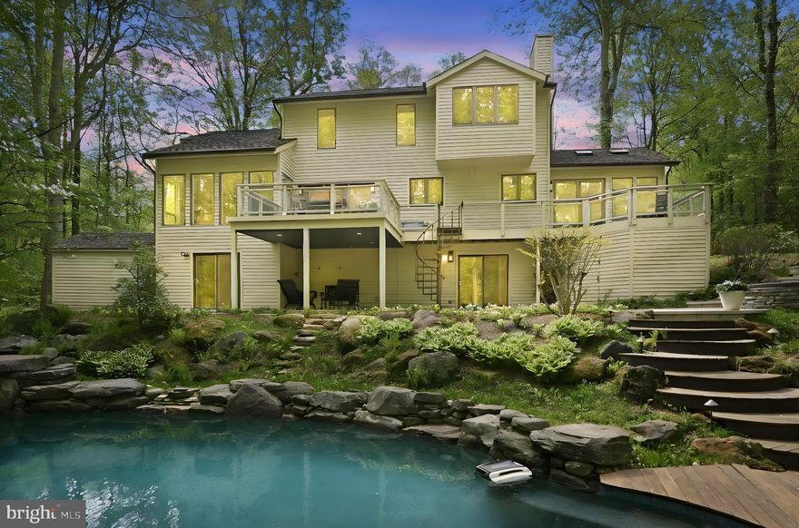 This unique Annapolitan Contemporary home is located in the quiet wooded enclave of WOODLORE. Which is one of the most coveted hidden gems offering an exceptional blend of refined living and natural beauty.  Just minutes from HISTORIC DOWNTOWN ANNAPOLIS, DC, & Baltimore. Clean lines, soaring ceilings, beautiful color palette and thoughtful design around EVERY corner.... TONS of WINDOWS & strategically placed skylights impart a cool serenity vibe as you look out over your own secluded, landscaped 1.08 acre sanctuary- FABULOUS CHEFS' KITCHEN (2025)  featuring large CENTER ISLAND oozes STYLE and FUNCTION with TWO-TONED cabinets, Granite Countertops & LOTS of Purpose-Driven STORAGE.  Custom Cabinetry paneled appliances blend in seamlessly while splashes of stainless-steel, including propane fueled Gas RANGE & sleek PULL-OUT microwave DRAWER create contrast and interest. Warm and inviting Family Room with Fireplace right off of the Kitchen creates the perfect space to stay connected and be part of every conversation, which flows into the amazing SUN ROOM with serene views and gorgeous natural sunlight.  Great for entertaining or relaxing with a good book or just enjoying nature's beauty or warmth of the fireplace. Sliders going to the rear deck and to the POOL. Separate DINING ROOM has French doors out to the rear deck & step-down to STUNNING LIVING ROOM with wall of windows that showcase the rich honey-colored HARDWOOD floors. The main-level OFFICE offers everyday convenience, perfect for working from home or managing daily tasks without navigating stairs.  Not to mention the recently updated beautiful Half BATHROOM on the main level. PLUS convenient LAUNDRY/STORAGE room on the main level. Upstairs, the Primary Bedroom boasts expansive Walk-In Closet, and luxurious Spa-like Bathroom with SAUNA, Soaking Tub, and Separate Shower with Steam, is sure to provide respite from stresses of the day. Two additional bedrooms and another beautifully updated Full Bathroom.  Downstairs, you will find an AWESOME MULTI- functional LIVING SPACE/EXCERCISE ROOM/FAMILY ROOM....1 GUEST BEDROOM/ FULL BATHROOM with Sliders to the Patio.  In addition, there is a large BONUS STORAGE/Utility area along with closets galore that will dazzle any highly organized individual. THE icing on THE CAKE (AND NATURALIST'S/ ENTERTAINER'S DREAM....) has to be this home's EXTRAORDINARY setting featuring INGROUND GUNITE, SALT-WATER, HEATED POOL , WATERFALL FEATURE, and lighting that ALL easily controlled from your cell phone.  A MASTER-GARDENER created a rolling array of mature showy perennial gardens providing year-round color and interest that back to protected woods that cannot be developed. Expansive TREX multi level decking meets you at the back doors and spills out into the pool area. With all of this in your own backyard, there's NO NEED to vacation or even leave this peaceful sanctuary in the woods. Where convenience meets tranquility as this home is ideally situated. If it's EXCITEMENT you crave, you are centrally located to incredible historic culture, food, entertainment & so much more with HISTORIC DOWNTOWN ANNAPOLIS, WASHINGTON DC, Baltimore, the BEACHES of Maryland's Eastern Shore. This is more than just a home; it's an exciting opportunity to live your best life enjoying family and friends. MUST SEE!