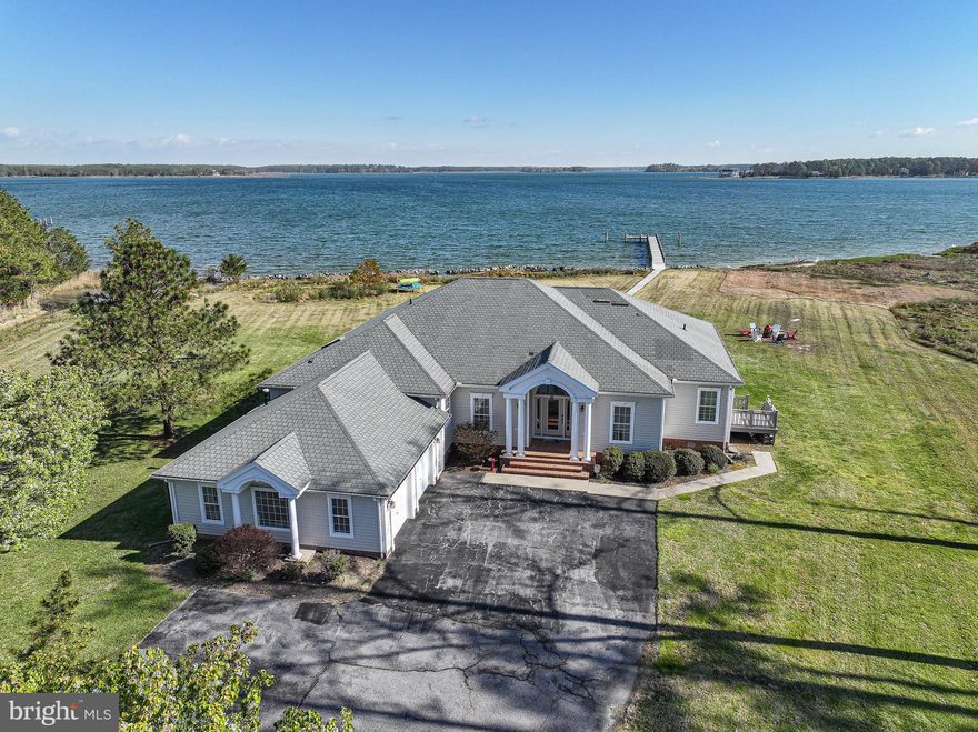 Fabulous waterfront home with modern flair and a stunning indoor pool, ideally located in McKeil Point, offering effortless one-level living and an open floor plan designed to capture spectacular, unobstructed water views from nearly every room. The thoughtfully designed split-bedroom layout ensures privacy, featuring a serene primary suite with direct access to the indoor pool, a luxurious bath, and a private waterside deck. The spacious kitchen includes a center island with bar seating and flows seamlessly into a separate dining room, perfect for entertaining. A light-filled family room opens to both the indoor pool and expansive waterside deck, creating the ultimate indoor-outdoor lifestyle. Set on over 6 acres along scenic Fishing Creek, the property boasts a rip-rapped shoreline, private pier and boardwalk, abundant wildlife, and a two-car side-loading garage, offering a rare blend of tranquility, space, and waterfront living at its finest.