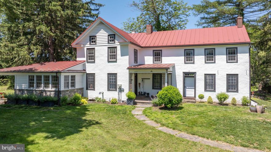 CHECK OUT THE VIRTUAL TOUR!!
Privately nestled at the end of a long, wooded drive, this quintessential Bucks County farmhouse sits atop Kintner Hill near the Delaware River.  Set on 80 unspoiled, conserved acres of woodland and pasture including the 5-acre building envelope, the c.1835 plaster-over-stone home is a rare blend of historical authenticity and thoughtful modern updates. A stately stone bank barn complements the house, creating a truly iconic country estate. Exuding old-world charm and steeped in history, the home is lovingly preserved with reverence to its 19th-century roots while embracing today’s comforts. It is an idyllic sanctuary for equestrians, hobby farmers, and nature lovers with miles of woodland trails for walking, running or riding. Bucks County Horse Park with its arenas, cross-country courses and miles of trails is just five minutes by trailer.  Step inside the welcoming front porch to a large foyer featuring Moravian tile floors, custom built-ins, and an efficient pellet stove. The character-rich living room has an original walk-in fireplace with a Jotul wood stove, charming pie stairs, and transom-topped doors that open to a 500sf patio overlooking the fenced lawn and surrounding nature. The family room is warm and inviting with exposed beams, stone fireplace with insert, and an original Bible cabinet – true echoes of a bygone era. The formal dining room is bright and spacious with a French door out to the garden.  The solid oak floors and hand-crafted windows throughout much of the main level reinforce the blend of tradition and modernity. At the heart of the home is the beautifully remodeled kitchen, featuring locally crafted soapstone counters and farmhouse sink, gleaming tile backsplash, induction range, stainless steel appliances, and soft-close cabinetry. Radiant-heated tile flooring extends into a sunny laundry/mudroom with wood countertops, utility sink, and access to a delightful covered back porch; perfect for enjoying a peaceful moment, listening to the birds and frogs, or watching your horses graze.  A first-floor bedroom and full bathroom provide ideal guest accommodation. The second level, accessible by pie stairs or a rear staircase, includes the primary suite and sitting room, dressing room, and full bathroom, as well as three cozy bedrooms and a half bathroom. The attic offers potential for expansion. Outdoors, the open lawn, fenced paddocks, and wooded trails make this a true hobby farm. The stable complex includes five acres of wood fenced paddocks, two stalls, a tack room, and three run-in sheds, equipped with water, electricity, mats, and fans. There's also a chicken coop and raised garden beds.  While secluded, the location is close to many amenities. The Delaware River, Lake Nockamixon State Park, Saucon Valley Country Club, and the Lehigh Valley's shopping and dining are all within 20 minutes. Just 90 minutes to NYC and Philadelphia, and under two hours to Harrisburg, this is the perfect, tranquil country escape, whether for weekends or a lifetime.