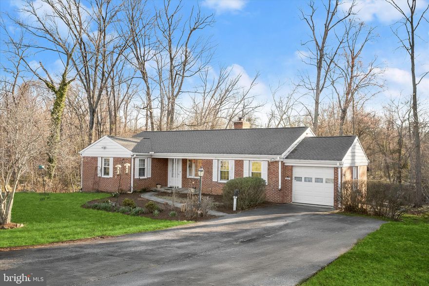 Welcome to the Milford community of Pikesville, where this charming brick rancher blends classic character with modern comfort. This inviting single-family home offers 3 bedrooms and 1.5 baths, ready for its next owner to make it their own. Step onto the front porch and enter a warm living room featuring gleaming hardwood floors, built-in bookcases, and a cozy gas-burning fireplace with a brick surround.  The sun-filled dining room, accented by chair rail molding, sits just off the kitchen, perfect for everyday meals or entertaining guests. The kitchen combines style and functionality with granite countertops, decorative backsplash, 42” oak cabinetry, and stainless steel appliances, along with convenient access to the attached garage.  Three generously sized bedrooms on the main level all feature hardwood floors. One bedroom includes knotty pine accents and built-in bookcases, while the others offer double-door closets for ample storage. A well-appointed hall bath and a lower-level powder room add to the home’s versatility.  The lower level provides endless potential, ideal for storage or ready to be transformed into additional living space, such as a media room, lounge, gym, or guest suite. An unfinished basement also includes a dedicated workshop area.  Step outside to a small patio and a wooded rear yard backing to Gwynns Falls, offering a peaceful, natural setting. Major systems include HVAC (2010) and water heater (2011). The property has not experienced flooding; however, buyers should verify flood insurance requirements.  Major commuter routes, including I-695, I-83, and I-95, are easily accessible. This solid home with great bones is perfect for buyers looking to add their personal touches and build equity.