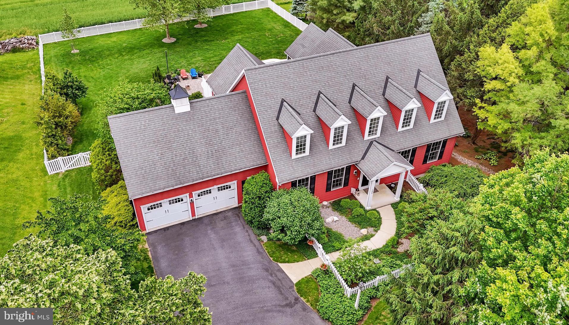 One of a kind—This stunning 4-bedroom, 3.5-bath home seamlessly blends timeless Colonial architecture with modern amenities and an open floor plan. Enjoy spacious indoor and outdoor living in the charming and highly sought-after town of Lititz. The interior offers generous living areas perfect for entertaining, while the resort-like backyard provides a private oasis for relaxation and outdoor gatherings.
From the moment you arrive, the beautifully manicured landscaping creates an inviting, picture-perfect setting. Step through the double front doors and be welcomed by vaulted ceilings, rich hardwood floors, and an open-concept layout ideal for both everyday living and entertaining.
Off the vaulted foyer a bonus room with built-ins and pocket french doors offers flexibility as a home office, playroom, or library. Across the foyer, the well-appointed formal dining room is perfect for hosting special occasions or large dinners. The great room's vaulted ceilings are flooded with natural light and anchored by a cozy propane fireplace, seamlessly transitioning into the gourmet kitchen featuring concrete counters and new appliances. Whether you're preparing meals or hosting gatherings, this space is designed for both function and connection. The main-floor primary suite is a private retreat, featuring double closets and a spa-like en-suite bathroom complete with double sinks, a jetted soaking tub and separate walk-in shower. A convenient half bath, laundry room and screened in porch round out the main level. Upstairs, two generously sized bedrooms each with walk-in closet and private vanities are connected by a shared Jack-and-Jill bath. The fully finished walk-out basement adds over 1,700 sqft of additional living space, including a fourth bedroom, full bathroom, family room, and kitchenette—ideal for guests, in-laws, or a home theater setup. Step outside to a private backyard oasis designed for year-round entertaining, featuring a heated saltwater pool, custom hardscaping, a dedicated fire-pit area, and lush, professionally landscaped grounds. For a higher vantage point, enjoy a sunset dinner on the upper deck or in the screened in porch. Additional highlights include the attached two-car garage and built-in storage shed, superior walls, central vac system and dual-zone climate control ensuring year-round comfort. This home is a true standout where comfort, craftsmanship and postcard-worthy views come together just minutes from Lititz’s vibrant downtown, shopping, dining, and top-tier healthcare.
Don’t miss the opportunity to make this extraordinary property your forever home. Schedule your private tour today!
