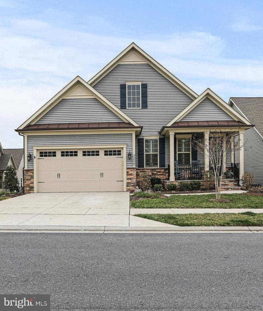 OFFER DEADLINE IS MONDAY APRIL 7 AT 5:00 PM.  Stunning Bennington Model in The Woodlands of Urbana – A Premier Active Adult Community!  Welcome to this beautiful single-family home nestled in the sought-after Woodlands of Urbana, a vibrant Active Adult Community offering resort-style amenities. This Bennington model features an inviting open-concept design with modern elegance throughout.  Step inside to a bright and spacious entryway, where a private home office sits to the left—perfect for a quiet retreat. The great room is a showstopper, boasting abundant natural light, plantation shutters, a stunning tray ceiling, and an expansive living area. The gourmet chef’s kitchen is a dream, featuring white cabinetry, quartz countertops, stainless steel appliances, a farmhouse sink, and an oversized island illuminated by stylish pendant lighting. The adjoining dining and living area seamlessly connects to a large covered rear porch, ideal for morning coffee or al fresco dining. Luxury Vinyl Plank (LVP) flooring flows throughout the main level for a seamless and sophisticated look.  The main-level primary suite is a private oasis, featuring a tray ceiling, dual walk-in closets, and a spa-like en-suite bath with a beautifully tiled shower with bench seating, dual shower heads, a double vanity, and a private water closet. A conveniently located laundry room sits just off the suite. This level also includes an additional  bedroom and full bath, the perfect retreat for visiting family and friends, and a spacious entry area from the two car garage, complete with a built in welcome center. The fully finished lower level offers an expansive living space, complete with a custom bar area, second family room—ideal for movie nights—plus a third bedroom and a third full bath and a large unfinished storage area.  French doors lead to a custom patio and a fully fenced backyard that backs to lush green space and  mature trees.   Enjoy resort-style living with exclusive community amenities, including a state-of-the-art clubhouse, fitness center, golf simulator, pickleball/tennis courts, an outdoor pool, putting green, walking trails, dog parks and more!  Don’t miss this opportunity to own a gorgeous home in Urbana’s premier 55+ communities!