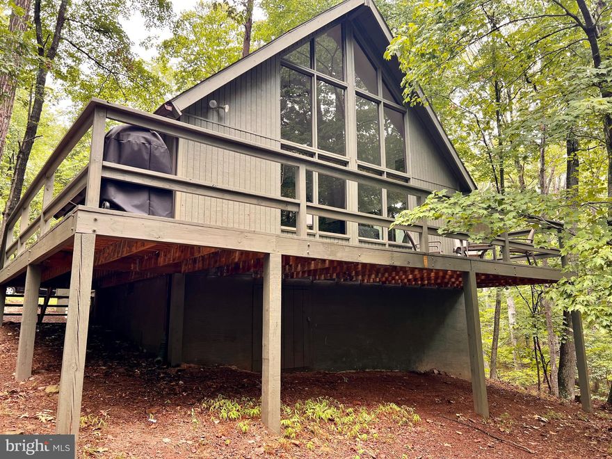 Welcome to your beautiful home in The Woods! You'll find the peace and quiet you seek in this two bedroom, one bath home that's nestled among the trees.  The lot that this lovingly maintained home sits on backs to a babbling creek and it truly does not get better than evenings spent on the wrap-around deck listening to the sounds of nature or viewing nature through the "wall of windows" looking out from inside upon the backyard and creek. The property also features a newer carport with attached workshop that is wired with electricity and would be suitable for many applications. The carport could also be used as a pavillion for family gatherings.  The possibilities are truly endless here!

BONUS!!!  Either a Class A (includes all amenties + golf-related amenities) or Class B (includes all amenities EXCEPT golf-related amenities) Membership to The Woods Resort is available with the home, as well, so you can take advantage of all this neighborhood has to offer!

Golf amenities (included with Class A Memberships) include golf (greens fees), driving range, chipping green, and a putting green; and both Class A and Class B Memberships include the following: Indoor Sports Center (racquetball, indoor pool, gym, aerobics room, laundry facilities, sauna, steam room, whirlpool, volleyball, indoor & outdoor tennis, indoor & outdoor basketball, shuffleboard, pickleball) , not one but TWO outdoor pools, Clubhouse, Club Room, baseball field, playground, and fishing ponds. Other amenities include: The Clubhouse Grille & Pub and the Sleepy Creek Spa & Salon.

The one-time initiation fee for membership is $3,150.00. The annual membership fee for Class A is $2,650 per year and a Class B Membership is $1,563.50.  However, for 2024,the annual membership fee will be prorated from March 1 until December 31!