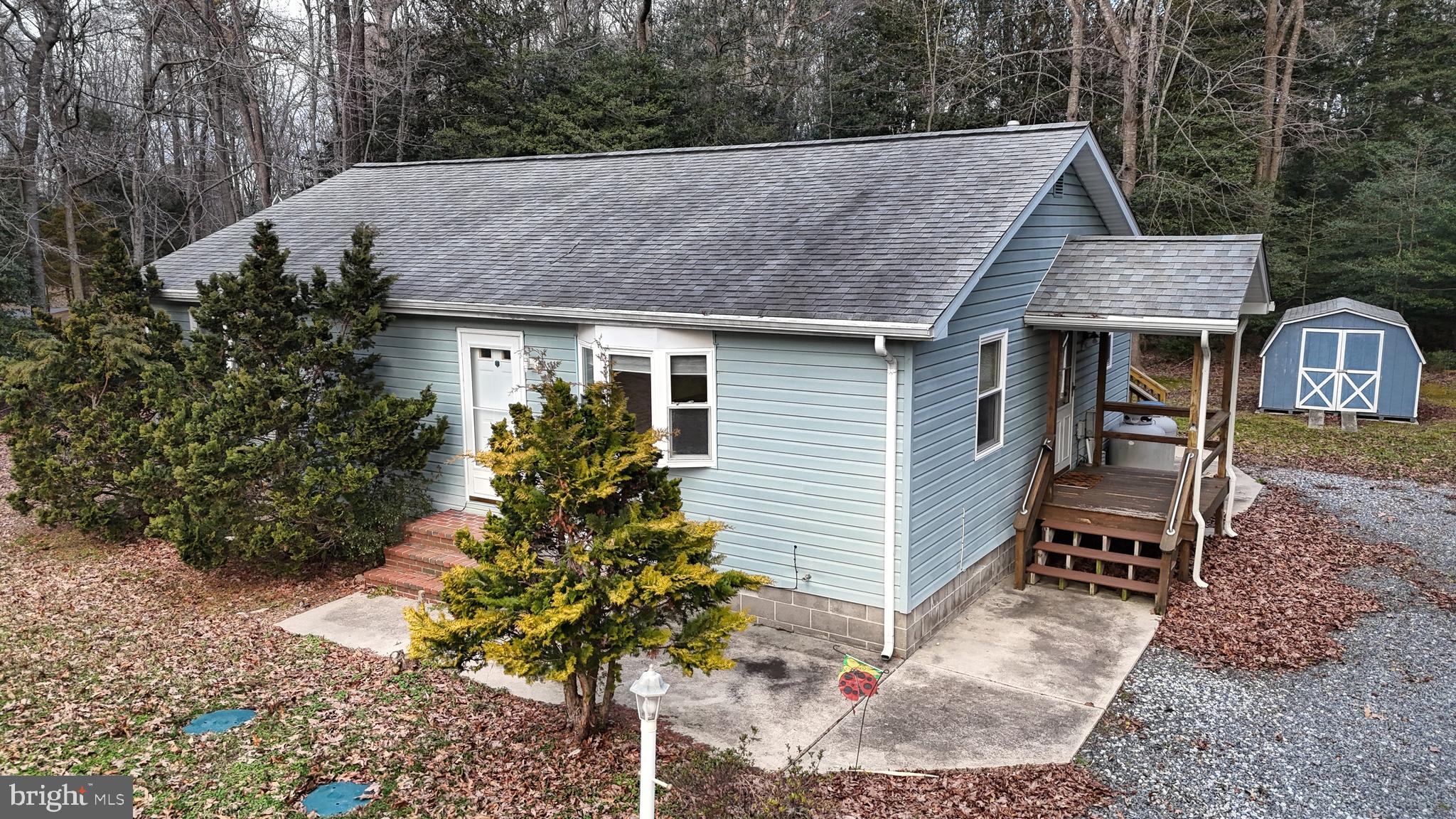 Welcome to 30421 W Beach Rd- Ranch style house featuring 2 bedrooms, 2 bathrooms and 1,384 SF of space. Want to be close to beach but not deal with all the beach traffic and headaches? This house is situated on 1/2-acre wooded lot, down a quiet back road and LESS than 8 miles to placing feet in the sand on Bethany Beach. As one enters the front door there's a large living room that opens directly into kitchen and dining room. Just off the dining room and through the sliding glass door is a spacious sunroom with its own ductless heating & cooling unit. Down the hallway are guest bedroom, primary bedroom with on-suite bathroom and stand-up shower. Need extra storage space? The rear yard has a nice size shed perfect for lawn mower, landscape tools and storage. If you're looking for a house with NO HOA, super low taxes, on quiet road that's minutes to the beach and on large lot with endless possibilities..... Then make sure you schedule a tour of this great house!
