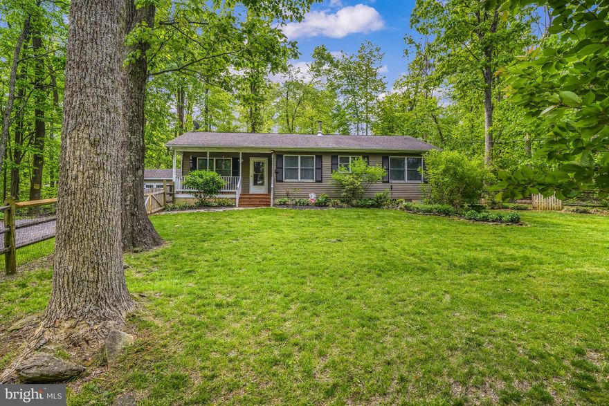 Perched atop a breathtaking mountain, this captivating home in Linden, VA offers a serene and picturesque retreat. Upon entering, you'll be greeted by an inviting open layout, seamlessly connecting the kitchen, dining, and living room areas. Immerse yourself in the beauty of stunning hardwood floors that grace the space, while a new dual ceiling fan and a Hearthstone wood stove provide both elegance and cozy warmth. The primary suite beckons with a modest walk-in closet and a partially updated full bathroom, featuring a tiled tub for luxurious relaxation. At the opposite end of the home, you'll discover two additional bedrooms adorned with the same timeless hardwood floors, accompanied by another full bathroom. The kitchen, designed for both functionality and charm, offers a cozy atmosphere and a small bar complemented by matching white appliances.

As you venture outside, a delightful surprise awaits in the form of a natural rock retaining wall, adding both character and functionality to the backyard. The meticulously manicured landscape boasts well-manicured trees, while the spacious front yard is securely enclosed by a tasteful fence. Step onto the recently sanded and stained decks, located at both the front and back of the house, and relish the perfect setting to immerse yourself in nature's tranquility.

Inside, the attention to detail continues with a newly wired light fixture adorning a low hanging bar light, creating a captivating ambiance for entertaining or relaxation. Additionally, a freshly painted bathroom breathes new life into the space, showcasing the care and consideration given to maintaining the home's impeccable condition.

With its breathtaking surroundings and meticulous updates, this extraordinary abode offers a harmonious blend of natural beauty and modern comfort. It presents an idyllic haven to call home, where you can fully immerse yourself in the splendor of your surroundings.