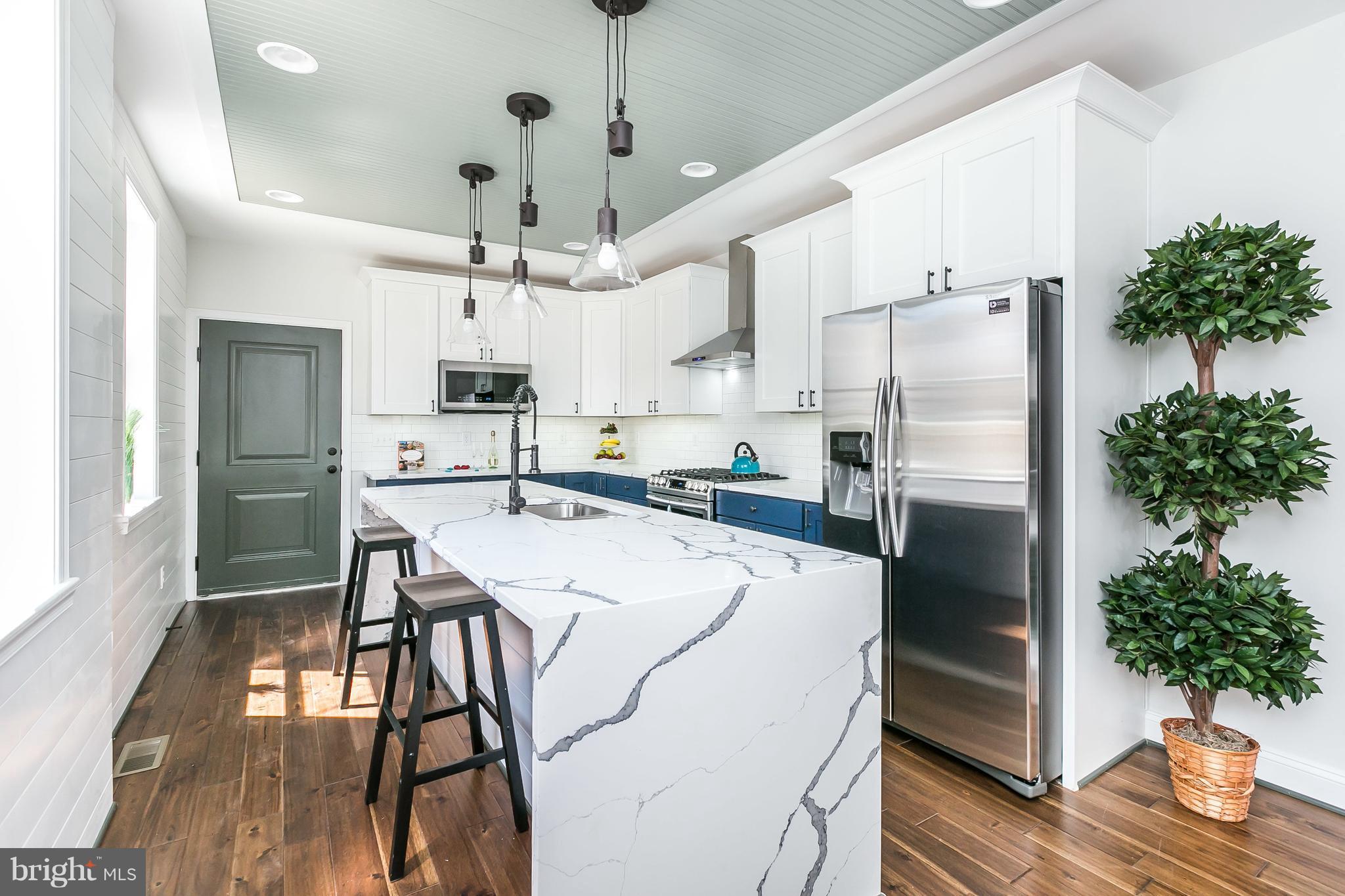 REMARKABLE RENOVATION W/ OVER 2000 SQ FT OF SPACE & SIDE LOAD GARAGE - A+ Canton location this large end of group offers hardwood flrs, exposed brick & beams, bead board ceiling, shiplap accent wall, modern board & batten siding look & a large island kitchen w/ quartz counters! Expansive second level w/ 3 spacious bedrooms, luxurious owner's bath, full sized laundry room & hallway access to deck!