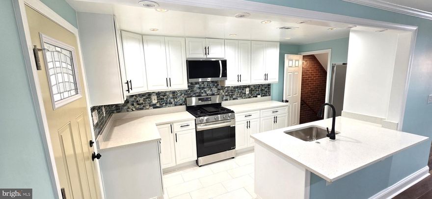 The value is in the detail.  Fabulous, immaculate  5-bedroom, 2-bath townhouse.  Entire interior completely redone.  All new systems including gas heat, central air, plumbing and electrical systems,  windows and doors.  Two (2) spectacular ceramic-tile full baths.  Fully equipped kitchen with all new stainless appliances including refrigerator, dishwasher, gas stove, and microwave oven.  New front porch, spacious rear covered patio for great entertaining.  Rear parking pad.  Upper level has 3 bedrooms and a full bath.   Lower level has 2 additional bedrooms, full bath, laundry area, utility room, and rear exit.