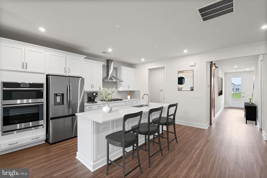 Embrace the Vera 30-F2 – Homesite 1096 at Hiatt Pointe—a two-car, front-load garage VILLA HOME with three bedrooms, two full bathrooms, and one half bathroom will be ready IMMEDIATELY. Built for the way you live, this factory-framed floorplan makes room for moments big and small. Be welcomed by 9’ ceilings on both levels, oak main stairs, and expertly selected finishes that make this villa feel effortlessly unique. The kitchen is complete with  soft-close cabinetry, quartz countertops, an island with a built-in trash can, and a pantry with solid shelving off the mud room. The open-concept great room features an electric fireplace and just outside the great room is a spacious 21’ x 8’ concrete patio. Throughout the home, enjoy luxury vinyl plank (LVP) flooring in the main living areas and primary bedroom ideal for durability and low-maintenance living. The main level primary suite includes a spa-inspired bathroom with dual vanities, soft-close cabinets, quartz countertops, a roll-in frameless shower with white floor-to-ceiling tile, and elongated comfort-height toilets. Upstairs, the flexible retreat, two secondary bedrooms, and one full bathroom offer the ideal setup for guests, hobbies, or versatile living. The two-car finished garage with electric opener and exterior keypad adds extra storage and convenience to your daily routine. This home features smart home technology and energy-saving innovations, including a Home Automation Package with IQ Panel 4, Ecobee® smart programmable thermostat, and more.  Being a new build, your home is constructed to the highest energy efficiency standards, comes with a post-settlement warranty, and has never been lived in before! Take advantage of closing cost assistance by choosing Intercoastal Mortgage and Walker Title. ----Discover Hiatt Pointe at Snowden Bridge, a gated active adult community designed for 55+ living, where every day brings new opportunities to connect, unwind, and thrive. Start your morning with a yoga session or workout in the fitness center before joining friends for a game of pickleball or billiards. In the afternoon, lounge by the outdoor pool and hot tub, then gather around the gas fire table as the sun sets. The clubhouse serves as the heart of the community, offering inviting spaces for social events, group activities, and quiet relaxation. Outdoor kitchens and scenic patio areas set the stage for effortless entertaining, while a low-maintenance lifestyle ensures more time for what matters most. With easy access to Route 7, I-81, and I-66, Hiatt Pointe offers the perfect blend of resort-style amenities and a welcoming, connected community.-----*Other homes sites and delivery dates may be available. Pricing, offers, and availability are subject to change without notice. Images, renderings, and site plans are for illustrative purposes only and may not reflect actual homes or features. Some images and renderings may depict interior designs created in collaboration with AI. Additional terms and conditions may apply. Please see a Van Metre Sales Advisor for details.