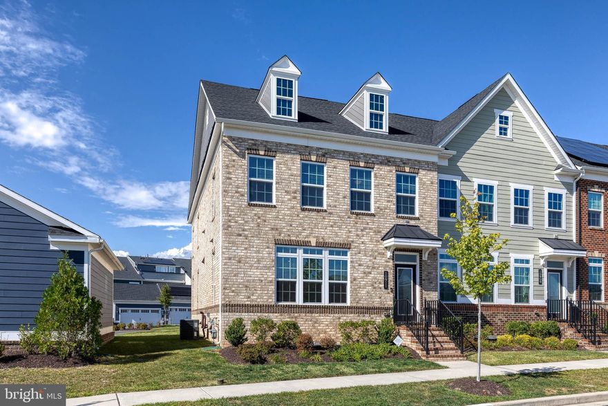 Welcome to this beautifully maintained end-of-row townhome in the thriving Greenleigh at Crossroads community, built in 2021. Featuring 4 bedrooms and 3.5 baths across approximately 3,437 sq ft of living space, this home has it all. Step into an open floor plan with dining room, kitchen and living areas on the main level. The gourmet kitchen boasts stainless steel appliances and a spacious layout with tons of cabinet space and functionality. Retreat to the large primary bedroom, complete with two walk-in closets, a double vanity, and a large double shower head shower in the en-suite bathroom. Two bedrooms and a full bathroom complete the upper level. A finished basement adds flexibility with the fourth bedroom that can be used as an office, gym, etc, and a large family room, while the outdoor trex deck provides the perfect spot for relaxing or entertaining. The detached two-car garage offers off-street parking and storage. Positioned within a vibrant neighborhood with amenities such as walking trails, a pool, clubhouse, playground and more, as well as shops, dining, parks, and convenient access to I-95 and I-695, this home blends modern comfort with everyday convenience.