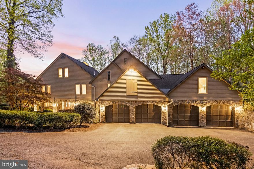 Welcome to this stunning custom-built home that seamlessly blends contemporary and log cabin styles. With 6 bedrooms, 7 full baths, and 1 half bath, this home offers plenty of space for your family and guests to relax and unwind. Situated on a 3.1 acre private lot that includes the adjacent 1.4 acre lot, you'll enjoy tranquil surroundings and a ton of privacy. The heart of the home is a late 1800s vintage 2 1/2 story log cabin, built and lived in by RJ Lewis, that has been restored and integrated into the modern luxury home. The main level features a large log cabin family room with a 2-story stone fireplace and large windows overlooking the garden patio, while the basement boasts a large rec room with a stone fireplace, built-in entertainment center, glass-topped bar, and beverage refrigerator. The home also boasts a completely renovated kitchen with high-end Wolf and Sub-zero appliances, honed cardosa granite countertops, and handmade Mexican mosaic tile backsplash. The first floor includes a separate living room and dining room with a deer antler chandelier, and the second floor features a large primary suite with his and hers walk-in closets, his and hers bathrooms, a newly renovated coffee bar area, and a balcony overlooking the garden patio area. Outdoor living is easy thanks to the stunning backyard with a pool and numerous decks and patios. The pool area was renovated in 2019 with new travertine pool deck stonework, new stone walls, and new trex handrails throughout, and there is extensive landscaping throughout the site, including a large stone fountain. Other features of the home include original wood beamed ceilings in the family room and lower level cabin rooms, natural materials and distinctive details with stone work, all updated LED lighting throughout, and a 4-car garage. With easy access to Route 7, this home is perfect for those who want luxury living in a peaceful setting.