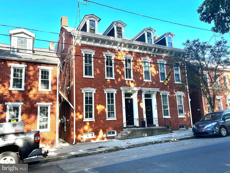 Incredible opportunity!  This versatile property has unlimited potential.  The brick Victorian duplex has 3276 sq ft on 3 floors for light business and residential use. With soaring 11' ceilings, spacious rooms and touches of original historic charm throughout, this property lends itself to various configurations that include: residence with office(s), short-term rental, multi-family possibilities or full light business or full residential uses.  It's location is within the tax opportunity zone, across from Locust Street Park, within steps of the main shopping & business area and walking/biking to River Park making it a highly attractive space in Columbia.  Columbia is on the rise with multiple development projects, boutique shops, restaurants, breweries, antique shopping and outdoor recreation. The type of architecture is drawing property renovators and the overall appeal of the area is making Columbia a sought after place to live, work and enjoy.  This is not to be passed over.
Renovations have not been finalized so that the new owner can make the final use/design their own:  What's been done: removal of partitioning to return the space to a single living/office space, repaired original trims, exposed brick in the dining room, addition of new powder room (incomplete) and new cabinetry and island in the kitchen, the second floor now enjoys space for a primary en suite, bedroom or sitting room with another multi use room and full bath.  This floor has access to a porch and exterior stairs to the rear.  The raising of the 3rd floor roof  created contemporary loft-like space with a side porch.    The property has potential for 5 bedrooms, 5.5 baths and/or office spaces.  The interior has been completely repainted.  Some systems are completely replaced/repaired while the A/C, baths, and finishing details remain incomplete to allow for a Buyer to reconfigure and design as desired.  With a 2 car garage in the back, it makes for an incredible property in a great Columbia location.  Priced to allow for finish work to be done.   Don't miss this opportunity!