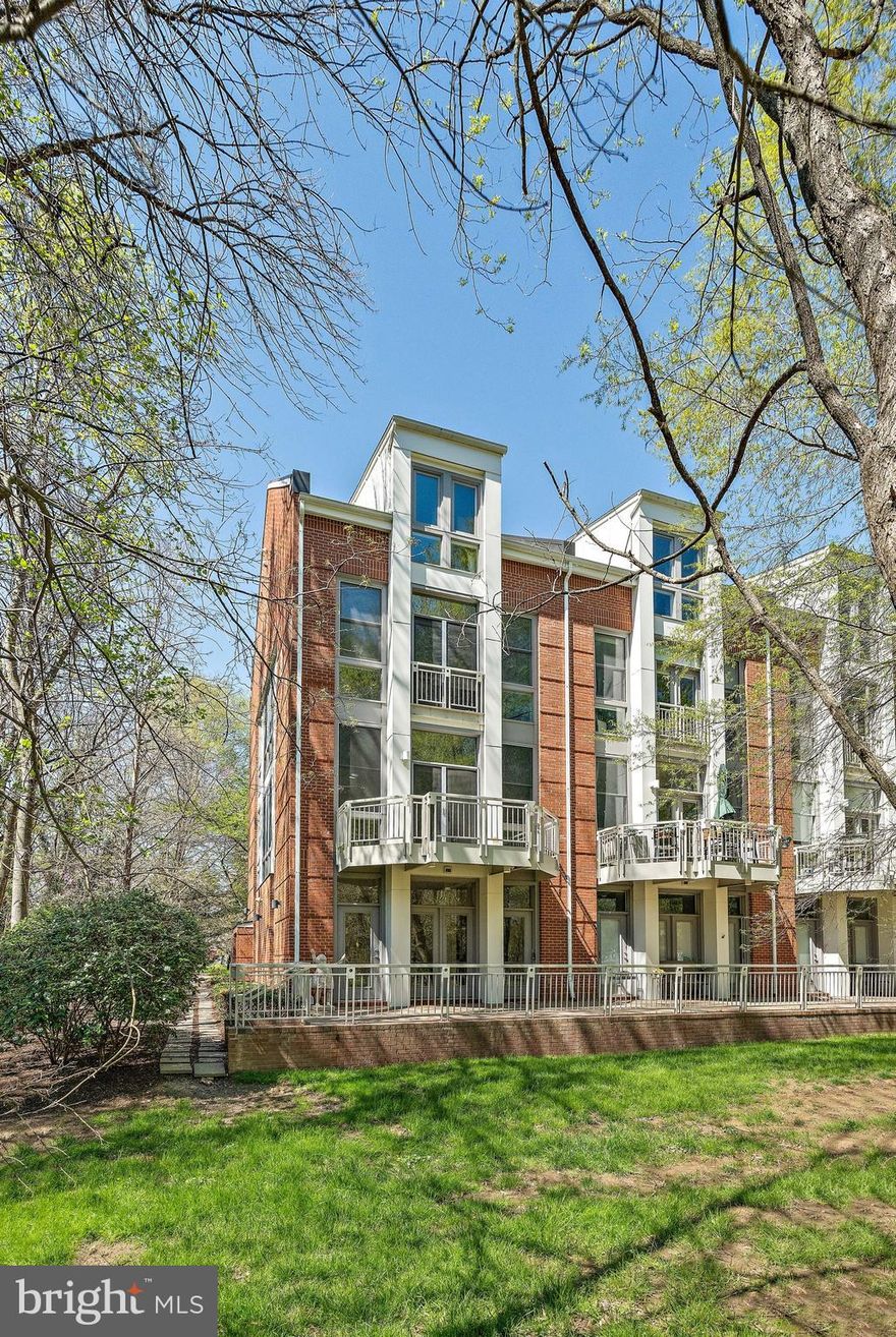 Offer deadline is 3pm Monday April 14th. This stunning, light-filled contemporary townhome sits on a premier end-unit lot, nestled at the edge of tranquil parkland with mature trees and a peaceful creek. Surrounded by nature on three sides yet just steps from the East Falls Church Metro, downtown Falls Church, W& OD Trail, shops, restaurants, and everyday conveniences, it truly offers the best of both worlds.

Inside, soaring 10-foot ceilings and dramatic floor-to-ceiling windows flood the space with natural light and offer breathtaking views of the surrounding conservation area. The open floor plan creates a seamless flow between the kitchen, dining, and living areas, making the home feel spacious, flexible, and perfect for both daily living and entertaining. 

The kitchen, thoughtfully renovated in 2018, boasts high-end finishes and top-tier appliances, including a Samsung FlexDuo gas range, a Bosch dishwasher, and a built-in Samsung microwave. Striking quartzite countertops, subway tile backsplash, a pantry, and a central island with a breakfast bar create a stylish and functional space that will delight any home chef.

Newly refinished hardwood floors span three levels of the home, carpet on the top floor and fresh paint throughout offer a move-in-ready experience. The expansive primary suite occupies an entire floor, offering privacy and luxury, while the top-level features two full-sized bedrooms, each with generous closets. The entry level has a flex room which can be used as a 4th bedroom or family room.  An upper-level laundry room adds everyday convenience, and the attached two-car garage provides private parking and additional storage.

Other significant updates include a new roof (2024), new garage door (2023), new HVAC (Upper Zone, 2021), and more. See the full list in the Documents section. This is a low-maintenance townhome, with HOA fees covering the care of shared outdoor spaces and exterior painting. Just outside your door, the single block immediately adjacent includes a coffee shop, South Block, smoothie bar, barre studio, bookstore, hair salon, and several restaurants—making urban living incredibly convenient while still enjoying the peace and beauty of a parkland setting. Tuckahoe/Williamsburg/Yorktown school pyramid. This home has it all! The total package — prime location, modern comfort, and unbeatable convenience!