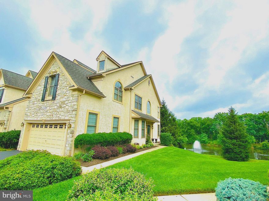 Be ready to be amazed when you tour this fabulous 3 bedroom, 2 ½ bath end unit carriage home in the highly sought community at The Reserve at Penn Crossing.  Located in the most desirable lot in the development, you will enjoy the magnificent view of the pond and the relaxing sound of the colored fountain from your private deck.  Everyday will feel like a vacation here. 
As you enter the front door, you will feel the positive energy from the open floor plan, 2 storey foyer and the arched window above the entryway that fills the room with tons of light.  On the right is the living room which can be used as a home office.  On the left is the formal dining room which is perfect for entertaining family and friends.  Beautiful hardwood floor flows from the foyer all the way to the kitchen and breakfast area.  The breathtaking 2-storey family room with palladian windows and gas fireplace brings the outside in.  From the family room, there are 2 french doors that lead to the outside deck with a stunning view.  The gorgeous eat-in kitchen is also open from the family room.  It features a kitchen island, corian countertop, a bar, gas cooktop, built-in oven, microwave, dishwasher and a french refrigerator.   There is also a breakfast area by the window and plenty of cabinet space for storage and pantry.  The powder room and laundry closet is also conveniently located on the main level. Go upstairs and you will get a great view of the family room and the pond from the curved balcony at the 2nd floor hall.  A double door will lead you to the elegant master bedroom suite with vaulted ceiling, recessed lighting, ceiling fan, spacious walk-in closet, sitting room and it’s own bathroom.  The sitting room can be used as an office, 2nd closet, craft room or exercise area.  The luxurious master bathroom has a whirlpool tub, glass shower stall, double sink and granite countertop.  There are 2 more spacious bedrooms with ceiling fans, spacious closet and a hall bath with a tub shower on this level.  All the carpets are newly installed.  The unfinished walk up basement gives you around  500 sqft of additional space for your hobbies and storage needs. The basement also has a hookup for laundry. Two car garage, driveway for 2 cars and overflow parking spaces are also available for this home. 
Aside from the pond with a fountain, the development also offers 2 dog parks and a walking trail to the shopping center.  No need to worry about cutting the grass and shoveling the snow as the HOA takes care of it for you. It is walking distance to shops and restaurants like Starbucks, Chick Fill-A, Applebees, Staples, Dollar Dollar Store and many more.  It is a short drive to major shopping centers like Plymouth Meeting Mall,  King of Prussia Mall and groceries like WholeFoods, Wegmans and Giant. The location is very ideal and close to train stations, hospitals, parks, major roads and highways like 202, 476, 276 and 76
