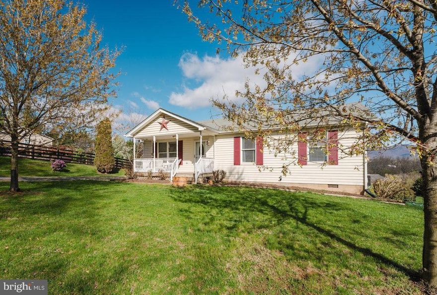 Charming ranch-style home in northern Page County situated on over two acres with breathtaking mountain views and no HOA! Move right into this ranch-style home nestled on over two open / partially fenced acres of picturesque countryside, just minutes from the charming Town of Luray, numerous public access points on the Shenandoah River, Luray Caverns, and Shenandoah National Park! Enjoy the ease of one-level living, where you can sip your morning coffee on the spacious rear deck, take in the serene sounds of country life, all while embracing the stunning mountain views. This inviting home features three bedrooms, one-and-a-half bathrooms, a large eat-in kitchen, a cozy living room great for relaxing or entertaining, a convenient laundry closet, and an enormous detached building ideal for storage and a workshop! With plenty of space for gatherings, this property makes a wonderful home or a savvy investment opportunity as short term vacation rentals (STRs) are allowed by right after obtaining a business license from Page County! Recent updates include a new HVAC unit (2023) and well pump (2024), ensuring comfort and efficiency for years to come. Set in a peaceful country setting with no HOA, yet close to outdoor adventures and local attractions, this home’s prime location in northern Page County, Virginia truly offers the best of both worlds. This gem of a home will not last long — call today to schedule a showing and make it yours!
