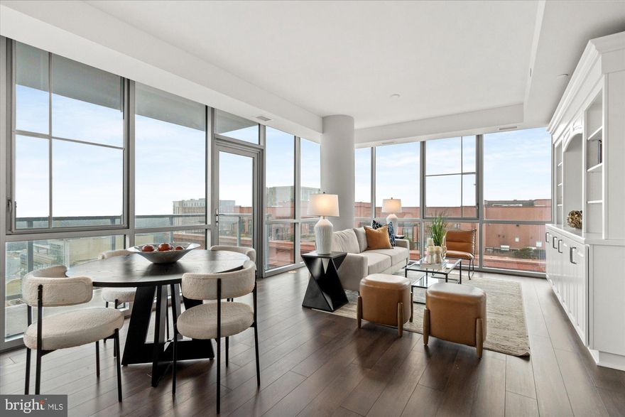 Modern, bright, and airy 2-bedroom, 2-bath corner condo perfectly situated in the heart of Pike & Rose. Enjoy luxury living with everything just steps away from dining, shopping, and entertainment.  This sophisticated residence features floor-to-ceiling windows that fill the space with natural light and showcase sweeping city and sunset views. The open-concept layout includes a chef’s kitchen with stainless steel appliances, a spa-inspired primary bath with dual vanities, a generous walk-in closet, and a second bedroom ideal for guests or a home office. Built-ins in the living room add both style and function. The unit comes with one assigned garage parking space and a private storage unit for convenience. Residents enjoy a full-service luxury building with a rooftop lounge, state-of-the-art fitness center, and 24-hour concierge. Positioned in one of the most walkable, vibrant neighborhoods, this condo puts the best of Pike & Rose just steps from your door while offering the pinnacle of modern urban luxury living.