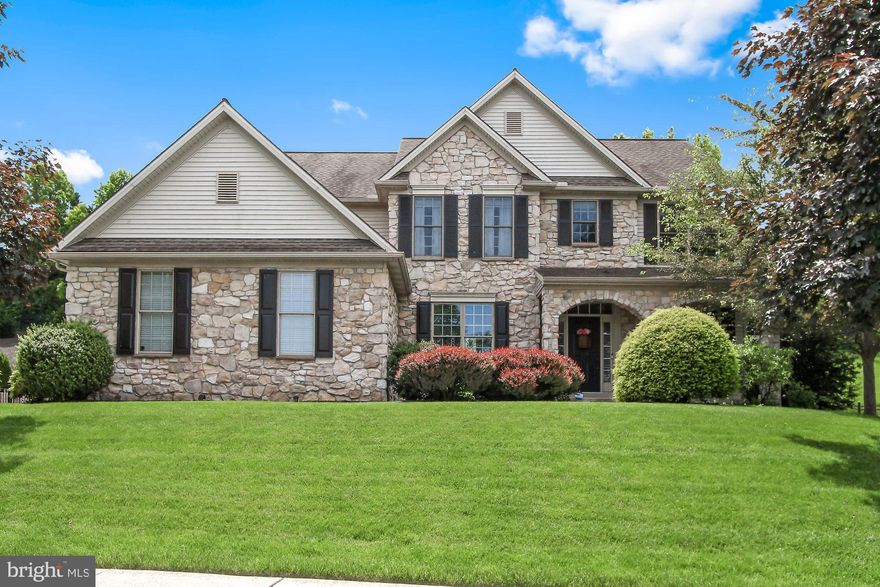 Your dream home is calling! You will fall in love with this stunning custom-built home in the desirable Springwood Neighborhood in Dallastown school district.  Attractive curb appeal, beautiful wood craftsmanship, hardwood floors throughout and truly open floor plan are just the beginning.  The grand foyer accented with multiple columns, tray ceilings and the many Pella windows that bring in lots of natural light create an elegant feel to the home. The first floor boasts a formal living and dining room, and a 2 story family room with a new floor to ceiling stacked stone gas fireplace. The staircase was recently updated with all new wood spindles. Enjoy cooking in the spacious kitchen with cherry cabinets, granite counter tops, an island and stainless steel appliances. There is a generous size master bedroom with a huge walk in closet plus full bath with a double sink granite vanity and Jacuzzi bathtub. There are 3 additional bedrooms and 1 full bath on the 2nd floor. The fully finished basement provides plenty of additional living space which includes an exercise room. There is a newly installed fence around the lovely private back yard with paver patio and top-notch landscaping. The HVAC system was replaced this year and a whole house generator is included plus a 3 car garage. Call for a private tour today!