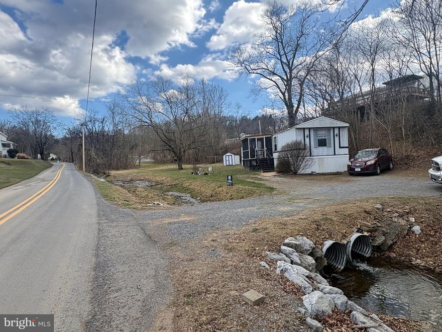 Escape to the country with this 1.52-acre property located just minutes from Berkeley Springs. This peaceful parcel offers a great blend of privacy and convenience, making it ideal for a full-time residence, weekend getaway, or investment opportunity.
The property includes a well-maintained 3 bedroom / 2 bath manufactured home already on site, providing immediate usability while you plan future improvements. With plenty manufactored open space, the land offers room for outdoor activities, gardening, or expanding the property to suit your needs.
Enjoy the charm and recreation that Berkeley Springs is known for, including its historic downtown, restaurants, shops, spas, and nearby state parks. Whether you're looking for a quiet retreat or a place to build your vision, this property offers plenty of potential.

***Note: Inside trailer pictures are older pics prior to current tenant moving in. ***
