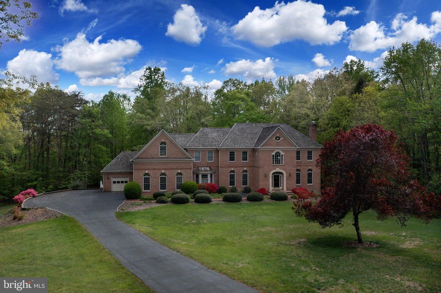 *** OFFER DEADLINE Of  MAY 1 at 2:00pm **** (read agent remarks for details) A mere 3 min. off of the #123 & a quiet world apart is this over 5+ acre home perched on one of the premier locations in Fairfax Station!  This lovely stately home is surrounded on 3 sides by parkland & backs to Sandy Run Park  & the Occoquan Reservoir. During winter months enjoy the sight of water peaking through the trees! Sandy Run is the semi-private county park which is only opened for the Crew Regattas in Spring & Fall. The rest of the year this park is your PRIVATE PARADISE!  Take your kayak or  canoe out & paddle away on this idyllic reservoir!  Meander up the pathway through your 5 acres of nature or stop for a moment by your own small waterfall.  Enjoy this lovingly cared for one-owner home & the spectacular open floorplan & coveted sprawling spaces punctuated by high ceilings, custom dental crown molding &  abounding hardwoods!  The sprawling foyer commands your attention with its marble floors & stately curved staircase! This level also has a large living room,  large formal dining room,  office with custom built-ins,  separate library/2nd office, spacious kitchen, bright breakfast nook, walk-in pantry, convenient mudroom- laundry room & 2 separate garage bays for a total of THREE cars.  But the high point of this level is the large Great Room with its curved window wall out to your own private retreat!  In addition to this, a large recently updated deck with composite railings runs the entire length of this home, beaconing one to further enjoy the outdoors.  Peek through the woods to make out your private trail to the water & the convenient large shed where tools & riding lawnmowers can be easily stored. This main level has 2 half baths , 2 wood-burning fireplaces & 2 staircases to the upper level. The upper level boasts a large family room overlook, a picturesque front nook area overlooking the expansive front lawn, plus 4 bedrooms & 4 accompanying full bathrooms!  The Primary Suite also  has another fireplace, a sitting room & double doors which take you to the one of the largest Primary bathrooms you might have seen. Need loads of closet space? This home has it! This area also has a second laundry room, utility sink & rows & rows of convenient closet space.  Moving to the lower level enjoy the convenience of a finished WALK-OUT basement with a kitchenette, large recreation room with the  4th fireplace, a pool table room, a finished storage area,  a breakfast nook area & a huge convenient unfinished storage area!  Need UPDATED SYSTEMS?  You have it here with = 3 HVAC systems, 2018, 2021, 2022 / 2 NEW HOT WATER HEATERS 2023 / KITCHEN APPLIANCES oven & microwave &  cooktop elements 2024, new fridge 2021 / NEW COMPOSITE DECK UPDATES in 2020.  Don't delay in viewing this one of a kind special home!