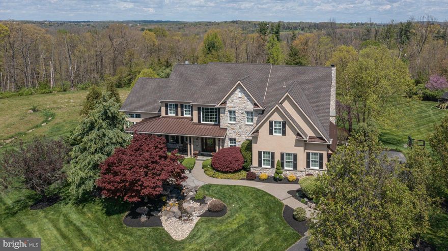 Backing to 100+ acres of preserved land and open space, this Estates at Dark Hollow beauty is a rare and special find. Nestled on a prime cul-de-sac lot in a serene setting, this renovated and expanded 5 bedroom, 4.5 bath home checks off everything on your wish list and more!  Its professional hardscape and landscape elements, including a tranquil waterfall near the front walkway captures your attention and lures you inside to discover even more impressive and remarkable features of this charming home. An abundance of natural light and openness surround you as you step in from the stunning blue stone porch into a welcoming two-story foyer adorn with a gracefully curved staircase and flanked by a wainscoted formal dining room with extensive moldings and private, two-door entry study making a perfect work-at-home setting. Follow the hand-hewn hardwood floors which guide you to the heart of the home; the open concept family room and grand gourmet kitchen. Certainly a chef’s pleasure, the expansive kitchen showcases an abundance of cherry cabinetry, large breakfast nook, an oversized island with seating for four, granite counters, coffee station and a suite of high-end, stainless-steel appliances. The breakfast area offers convenient access to the rear, upper deck from its oversized slider and leads seamlessly to the soaring two-story family room adorn with second staircase and wall of windows where family and guests can gather around the cozy floor-to-ceiling, gas fireplace on chilly evenings creating the perfect ambiance for relaxation. Utilized in diverse ways, the neighboring conservatory is a notable space with its three walls of windows, grand vaulted, wood trimmed beamed ceiling, stone fireplace and built-in bar area. Completing the main level is a convenient half bath and spacious laundry/mud room. Residing upstairs at the top of the landing is the double-door entrance to the primary suite with an eye-catching tray ceiling, sitting area, plantation shutters and large walk-in closet. Indulge yourself in this main master bath highlighting a platform Jacuzzi tub, oversized walk-in shower, and dual sink vanity. A spacious ensuite bedroom can also be found on this level as well as two other bedrooms which share a convenient Jack and Jill bath. Downstairs, the finished walkout lower level offers additional living space including a full bath, bedroom, media room, billiards/game room, exercise room and ideal storage. Outside an enormous backyard oasis is a dream come true with inground pool adorn with waterfall and hot tub, entertainment areas including a covered, upper deck sitting space with stone fireplace and lower expanded patio area boasting a kitchen/prep area with window seating, Jacuzzi and built-in grill. Located in a highly desirable, quiet neighborhood in Jamison with many entertainment and dining options in nearby Doylestown and Newtown. Come tour and enjoy breathtaking views from every window of this exquisite home today!