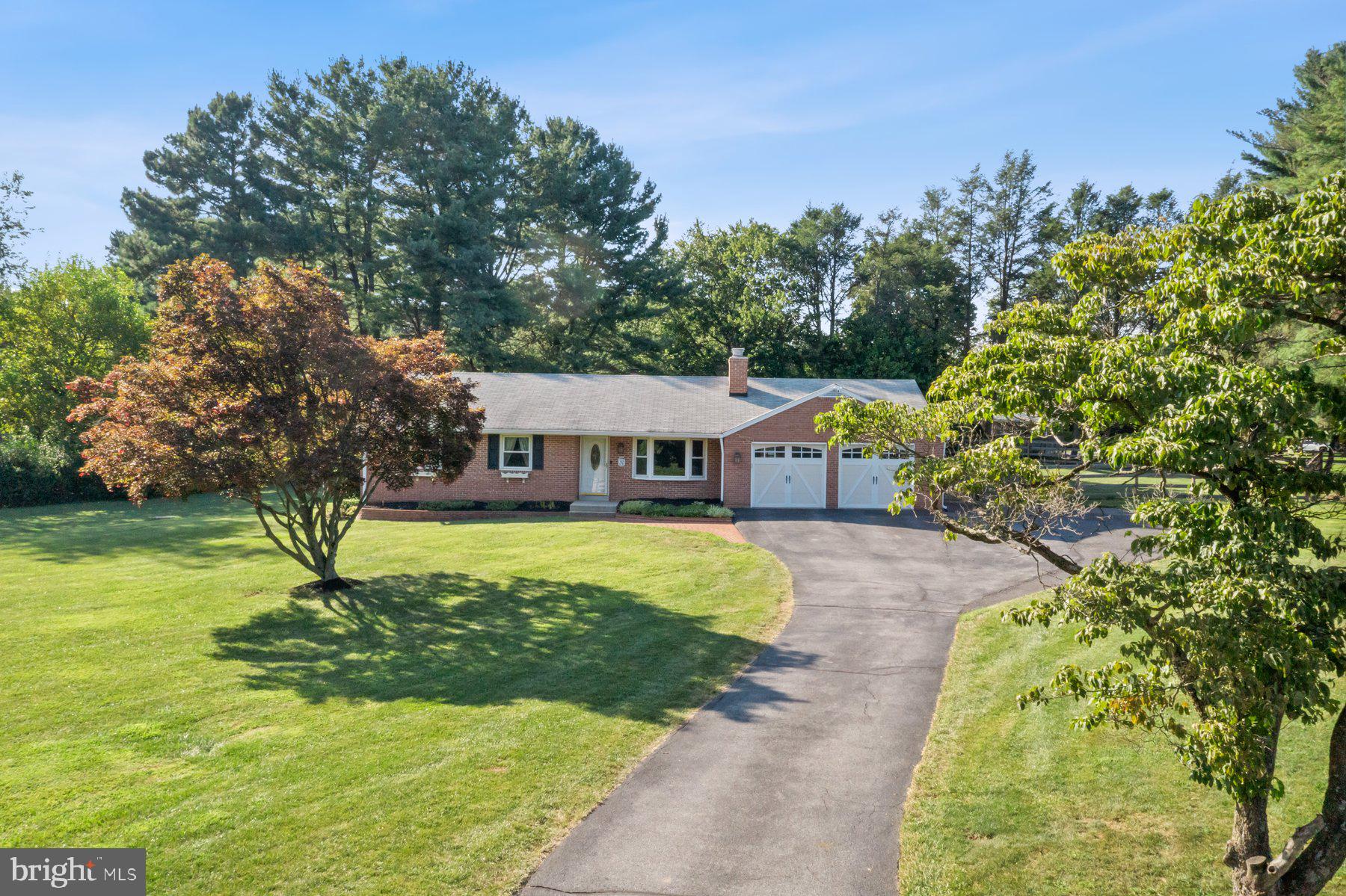 Welcome to this beautiful and highly desirable brick ranch style home on a corner lot of 1.26 acres, offering over 2,970 sq ft of living space, 3 bedrooms, and 3 bathrooms. Enjoy the gleaming refinished hardwood floors in the living room and bedrooms. The great room with well-equipped stainless steel kitchen, spacious dining area and living space overlooks a huge screened porch adjoining the expansive outdoor deck space. The updated kitchen features granite countertops, stainless steel appliances, including 3 ovens, perfect for hosting guests. The deck and porch leading to the stunning heated, gunite pool in the huge beautifully landscaped fenced yard is perfect for relaxing and entertaining. The cozy great room and adjoining living room each boasts brick-front wood burning fireplaces. The spacious expanded owner’s suite includes a huge walk-in closet, second separate closet, and a remodeled bathroom with double vanity, and private shower providing a spa-like experience. Two additional bedrooms and an updated full hall bath with tub/shower complete the main level. The finished lower level offers even more living space with a large family room with the third wood burning fireplace, a versatile flex room with a third full bath, and a generous storage area with laundry. The oversized attached two-car garage includes extensive room for storage. Plenty of additional parking in the expanded driveway. Recent upgrades include: refinished hardwood floors, freshly painted rooms throughout the home, new SS refrigerator with ice-maker, refinished deck and screened porch floors, new screens on porch, and new shower glass in owner's suite bath. SCREENS AND DOORS OF SCREENED PORCH ARE EXPECTED TO BE REPLACED ON TUESDAY, AUGUST 5TH