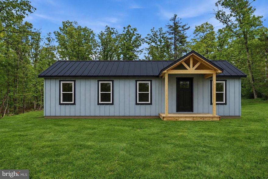 Brand new construction in the heart of Wardensville, West Virginia, offering 3 bedrooms, 2 bathrooms, and set on 2.25 private acres. Conveniently located approximately 3 miles up Trout Run Road, this home provides the perfect blend of rural privacy while still being close to town conveniences and the charm of the Eastern Panhandle. Property features public water, private septic, and availability for high-speed fiber optic internet.

Inside, you’ll find cathedral ceilings in the main living area and 9-foot ceilings throughout, creating an open, airy feel filled with natural light. The kitchen is thoughtfully designed with quartz countertops, stainless steel appliances, a built-in microwave, and beautiful navy “Warren style” cabinetry that adds a modern yet timeless touch. The primary suite includes a spacious walk-in closet and a private en-suite bath for comfort and convenience.

Exterior highlights include vertical board and batten Smart siding in the color “Nautical Mist,” a concrete front porch, and a rear patio—ideal for enjoying the peaceful surroundings and mountain air. Durable LVP flooring flows throughout the entire home, offering both style and easy maintenance.

Enjoy new construction living in beautiful Wardensville—a quiet mountain town known for its scenic setting, small-town charm, and access to nearby outdoor recreation, while still being within reach of Winchester and the surrounding Shenandoah Valley.