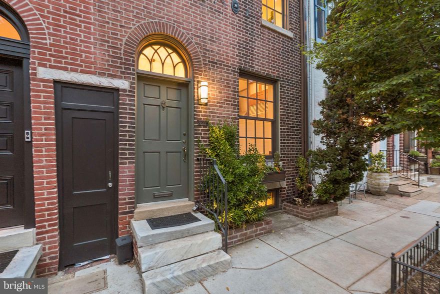 A rare offering on a coveted Fitler Square block, 2415 Pine Street sits on a double lot with a stunning 60-foot garden - an outdoor space rarely found in Center City. Professionally landscaped with bluestone patios, irrigation, ambient lighting, and access to Panama Street, the garden offers multiple areas for entertaining and dining, all designed for beauty and low maintenance with lush evergreen plantings. This architect-renovated home blends classic character with thoughtful upgrades. The bright, open living and dining area features 10-foot ceilings, a wood-burning fireplace with reclaimed wood mantle, and floor-to-ceiling French doors for seamless indoor-outdoor living and Phantom retractable screens. The kitchen is both refined and functional, with quartzite countertops, a full-height stone backsplash, custom cabinetry, and premium appliances. The finished lower level offers flexible space with custom built-ins, wine storage, exposed beams, a Murphy bed, and full bath, perfect for guests, an office, or additional living. A laundry room completes this level. Upstairs, the second floor features spacious, light-filled bedrooms, including rear-facing rooms with peaceful garden views. The third floor has been thoughtfully transformed into a functional primary suite with custom-built closets, a private deck with skyline views, and curated finishes including Roman shades and wallpaper. This home has also undergone extensive capital improvements, including a completely new dual-zone HVAC system (2020) with integrated air purification, full roof replacement (2020), comprehensive chimney system upgrade, and basement waterproofing system with French drain that carries a lifetime transferable warranty. Renovated by architect Brett Weber and located just steps from Fitler Square, Schuylkill River Park, and neighborhood favorites, this is a rare opportunity to own a move-in-ready home with exceptional outdoor space and major upgrades already completed in one of Philadelphia’s most desirable neighborhoods.