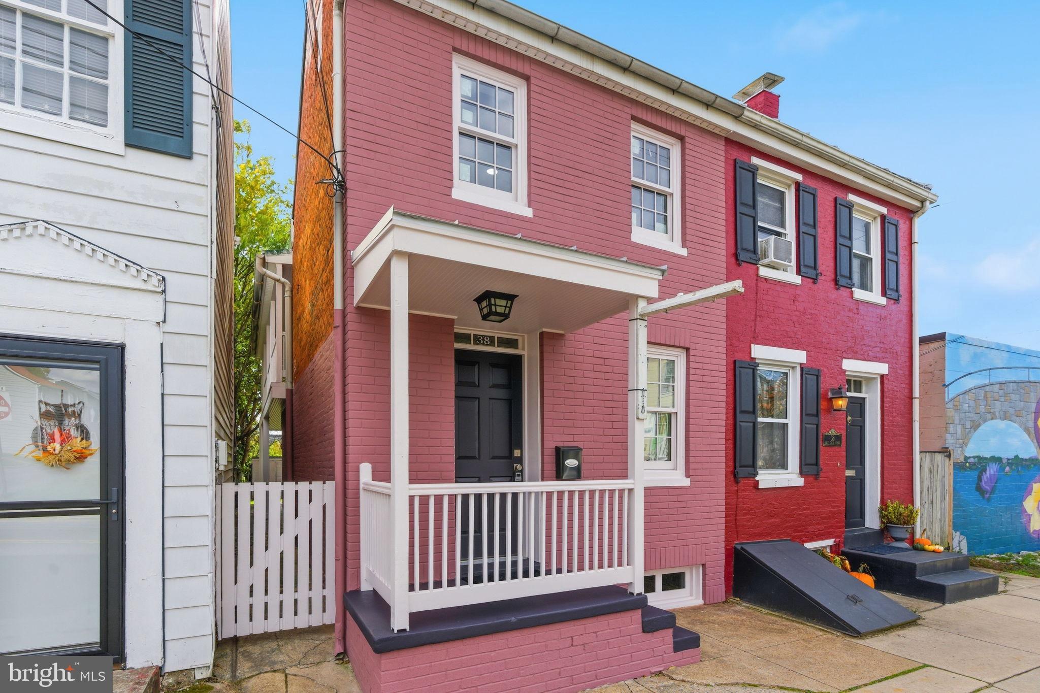Nestled in the vibrant heart of Downtown Frederick, this exquisitely reimagined end-of-row townhouse, originally built in 1900, has undergone a complete custom renovation in 2025 to seamlessly blend historic charm with modern luxury.
Behind its elegant Federal-style brick façade, every inch of the home has been thoughtfully redesigned with an updated floorplan and all-new systems, including plumbing, electrical service, insulation, and an efficient mini-split heat pump system. A whole-house water filtration system ensures clean, high-quality water throughout.
Step inside to discover real Brazilian cherry hardwood floors that flow through the open-concept living area, complemented by custom-made Douglas Fir wood doors and front windows—true craftsmanship rarely seen today. The gourmet eat-in kitchen is a showpiece, featuring an all-new suite of smart appliances, sleek custom cabinetry, and premium finishes designed for both beauty and function.
A hidden laundry area with an all-in-one washer/dryer unit and on-demand hot water heater maximizes efficiency while maintaining a clean, streamlined aesthetic. Under-stair storage adds clever practicality to the space.
Upstairs, the bright and spacious bedrooms includes a walk-in closet, while the updated bathrooms feature contemporary tilework and modern fixtures.
Outside, enjoy your own secluded backyard patio, ideal for relaxing or entertaining in privacy. Convenient off-street parking is available directly behind the property (neighbor contact available), offering rare ease in Downtown Frederick.
Perfectly situated within walking distance of the city’s award-winning restaurants, boutique shops, and cultural attractions, this home combines the best of urban living with timeless design and modern comfort. With every system and surface brand new, this property is not just move-in ready—it’s future-ready.
Experience the ultimate Downtown Frederick lifestyle in this completely renovated historic gem, where every detail has been carefully curated for quality, comfort, and style.