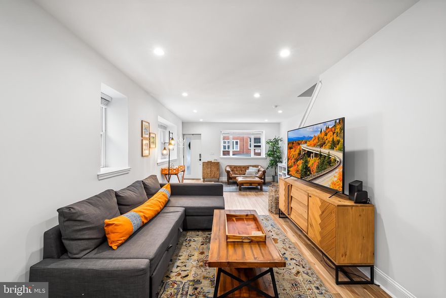 Welcome to 1007 McKean Street, a tastefully renovated and pristinely kept three bedroom corner home with a roof deck in the ever popular East Passyunk Crossing neighborhood of Philadelphia.  Step inside to the open concept living, dining and kitchen space and you immediately notice the abundance of natural light from the oversized front and side windows.  The first floor space is unified with calming light gray walls anchored by mid-tone hardwood floors that continue throughout the upper floors of this home.  There is plenty of space for all your large-scale furniture including a full dining set.  The kitchen space seamlessly blends into the living area with its timeless white shaker-style cabinetry accented by light gray waterfall style quartz countertops, smooth subway tile backsplash and KitchenAid stainless-steel appliances. The kitchen is smartly designed with an abundance of counter space including a breakfast bar that is the perfect spot for casual everyday dining.  Bonus – there is a large pantry closet with shelving for storing all your small appliances! A powder room is tucked away on the first floor for convenience. On the second floor, there are two guest bedrooms, a full guest bathroom and the primary suite with an en suite bathroom.  The first bedroom is a good-size with a double closet.  The second bedroom is the smallest of the three and works well as guest space with a daybed or a home office. The guest bathroom brings a bit of indulgence into everyday living with its walk-in shower complete with waterfall showerhead system accented by modern gray tile, cool penny tile shower floor and a two-toned vanity.  The primary suite easily accommodates a king sized bed and has a full wall of closet space. The en suite primary bathroom is designed for relaxation with luxury updates including a big soaking tub and another walk-in shower outfitted with a waterfall shower head system with body jets for a spa-like experience at home. There is a double vanity in a chic dark wood tone for extra storage accented by dual LED wall mirrors.  Accessible via an interior stairwell from the upstairs level, the roof deck is an urban oasis that offers stunning panoramic views of the Philly skyline and is the perfect spot to lounge in the warmer months. This home is truly nestled in the perfect location, especially if you are a foodie.  In just a few minutes you could walk to all the award winning eateries along the Passyunk Avenue corridor including Le Virtu, Artisan Boulanger Patissier and Gabriella’s Vietnam to name a few.  It is also an easy walk to all the shopping and dining at BOK and just four blocks to get to the Broad Street subway line. Located in the Southwark Elementary School catchment.