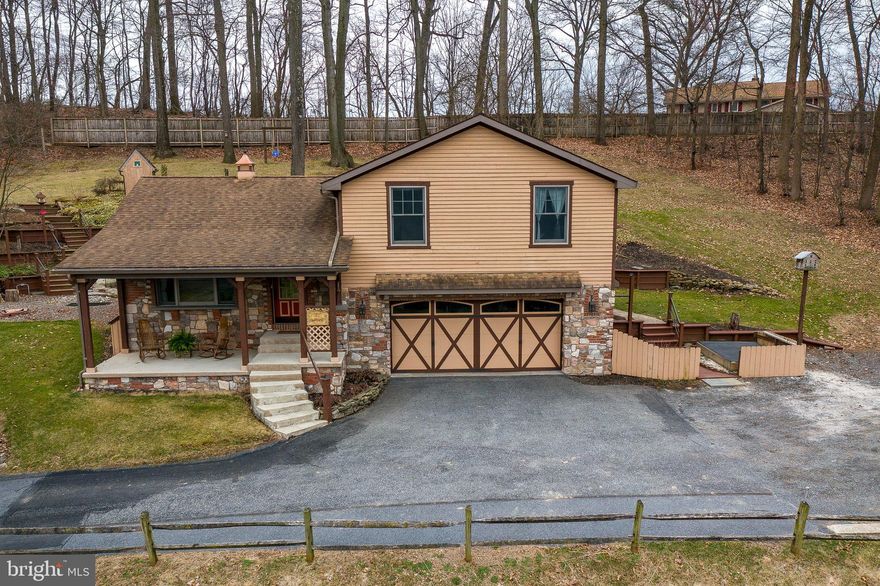 Welcome to a private retreat with modern conveniences. This 3 bedroom, 2 bath home has picturesque views of meadows, a pond, and farmland from both the front porch and living room. The kitchen features stonework and exposed beam walls, tile countertops and backsplash, butcher block island, stainless refrigerator and range hood, and a garden window and sliding glass door with natural light and views of nature. The upstairs features the main bedroom with a centerpiece stonework wall and large closet, full bath with another garden window, and 2 additional bedrooms with natural light. The lower level offers an attached 2-car garage, laundry room, and spacious finished basement flexible for your dreams of entertaining, play room, office, etc. Complete with a full bath with tile countertops and walk-in tile shower! The backyard had a large deck and covered grill bar for all of your entertaining, as well as expansive views of rural landscape. Conveniently located just a short drive to Harrisburg, Lancaster and only minutes to the PA Turnpike. Don't miss this retreat to call home!