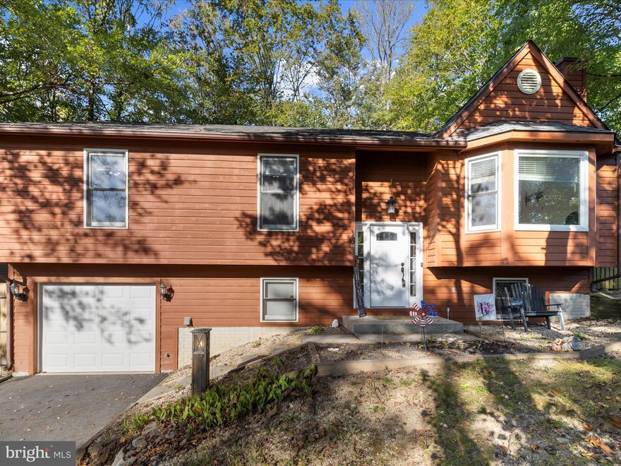 This beautifully updated 3 bedroom, 2.5 bath split foyer with attached garage is tucked away in the highly sought-after Lake Linganore community. Major updates include new carpet,  a new 30-year architectural shingled roof (2022) and a fully remodeled kitchen (2018) with hardwood floors, granite countertops, stainless steel appliances, a center island, and ceramic tile backsplash.

The open layout features cathedral ceilings, skylights for natural light, and a cozy wood-burning fireplace in the living room. The spacious primary suite offers a stunning, newly renovated bath with an oversized walk-in shower featuring stone floors, custom tile surround, rain shower, jets, and light-sensing LED lighting. The Days on Market reflect a previous Buyer's Home Sale Contingency!

The lower level is a showstopper with engineered wood floors, stone accent walls, custom burnt wood rails, built-in desk, wet bar with cabinetry and mini-fridge, plus a unique half bath with barrel sink and pocket door. A barn door reveals the laundry room with automatic lighting, and the walkout leads to the garage.

Step outside to a large, newly renovated deck—perfect for entertaining. All of this just steps from Lake Merle and the Balmoral Trail Head. A rare find with modern updates in one of the area’s most desirable lake communities!