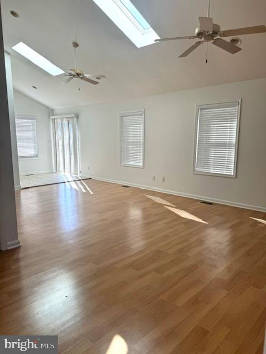 2764 SQ FEET OF LIVING SPACE!!!  AWESOME HOUSE!!! 4 BEDROOM / 3 FULL BATHS!!   LIVING ROOM WITH HARDWOOD FLOORS AND FIREPLACE!!  SUPER LARGE KITCHEN WITH BREAKFAST BAR, DESK AREA, PANTRY AND CORIAN COUNTERTOPS!!!  ENORMOUS LAUNDRY ROOM ON MAIN LEVEL WITH FRONT LOADING WASHER AND DRYER!! PRIMARY BEDROOM ON MAIN LEVEL HAS CATHEDRAL CEILINGS, A FULL BATH AND LARGE WALK IN CLOSET!!  2ND BEDROOM ON MAIN  LEVEL IS LARGE!!   CEDAR LINED HALL CLOSET!! UPDATED STYLISH HALL BATHROOM!! HUGE FAMILY ROOM HAS A SOARING CATHEDRAL CEILING WITH SKYLIGHTS!!  LOWER LEVEL HAS A FAMILY ROOM, TWO ADDITIONAL BEDROOMS AND TWO STORAGE ROOMS WITH SHELVING!!  FENCED BACK YARD!!  DECK!!  SHED!!  DRIVEWAY PARKING!!  ONE BLOCK FROM THE WATER!!!  BOAT LAUNCH FOR JUST A $125 YEARLY FEE!!  GO SEE THIS GREAT HOME TODAY!!!