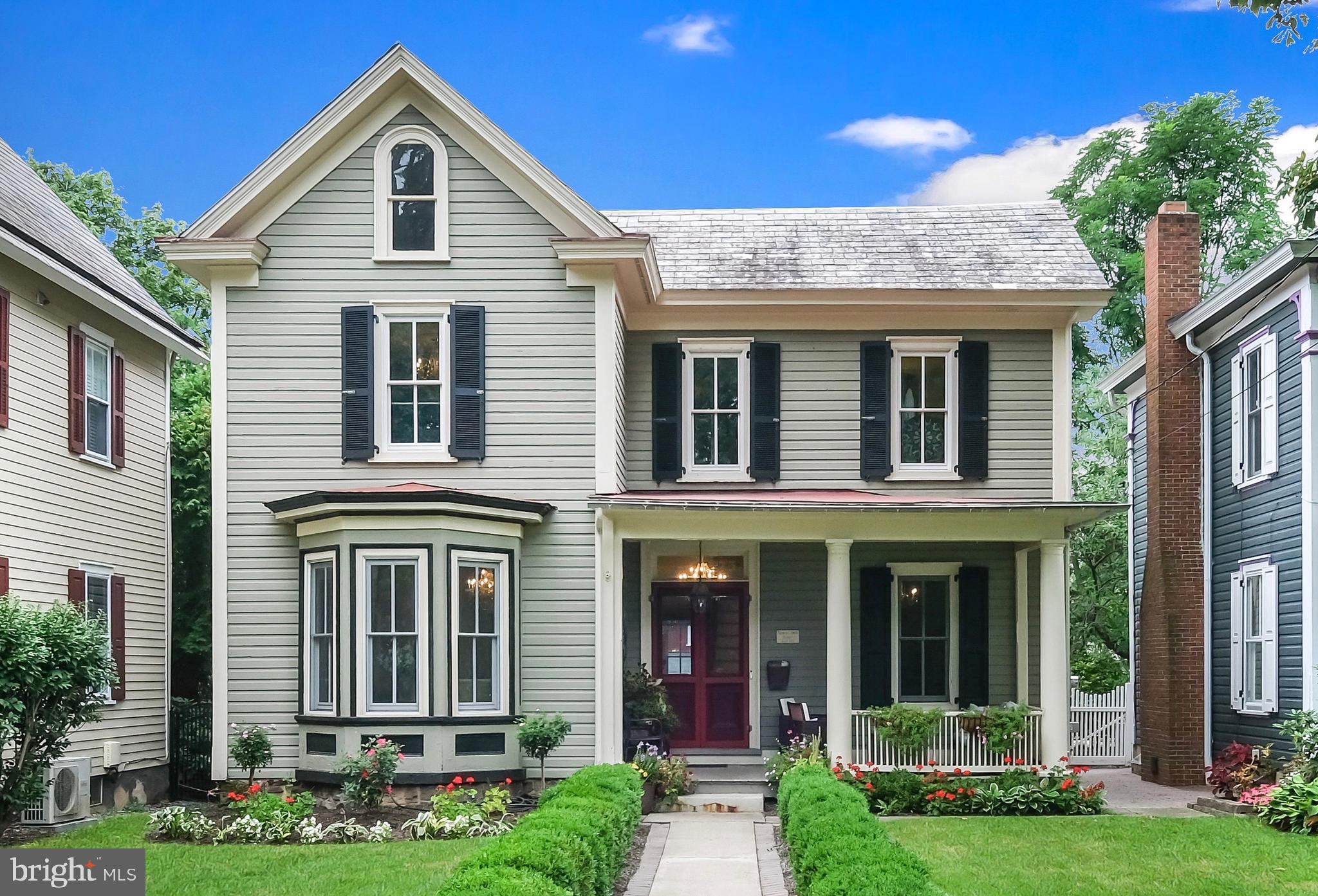 Located on one of the most coveted streets in Doylestown Borough, this remarkable residence is a true masterpiece. The beautiful Victorian has been fully remodeled, seamlessly blending historic charm with modern convenience.
Step inside and be captivated by the artistry and detail throughout, beginning with the stunning stained-glass front door and transom, period-appropriate doors and hardware, and custom craftsmanship at every turn, including a hidden door. The walls are adorned with exquisite hand-painted Chinoiserie murals by renowned local artist Lucy Bernstein, whose work has graced the prestigious Bucks County Designer House. The chef’s kitchen is designed to impress, featuring light cherry cabinetry, a 48” Viking range, and a Sub-Zero refrigerator—perfect for culinary enthusiasts.
The main level offers excellent flow for everyday living and entertaining. The home boasts three luxurious ensuite bedrooms, plus a first-floor bedroom (the fourth bedroom) with direct access to the fourth full bathroom.
One of the property’s most extraordinary features is the converted barn, which offers garage parking for two cars (including an EV charger) plus an additional storage bay. On the barn’s second floor is a fully finished space with a full bathroom and kitchenette, providing versatile functionality as a unique guest or in-law suite, a home office, or a creative studio. You’ll appreciate this conversion, which accents the original barn features of random-width flooring, exposed wood beams, and walls, while being built with efficiency in mind, including a tankless water heater and spray foam insulation. The garage doors open to Beek Street, the alley at the rear of the property, providing additional convenience and access.
The outdoor space is equally enchanting, with a beautiful patio and an open, fully fenced backyard—perfect for relaxation or entertaining while enjoying the thoughtfully landscaped surroundings. Best of all, you’re just steps from the vibrant shops, dining, and culture of Doylestown Borough. A rare opportunity to own a true work of art in a prime location!
