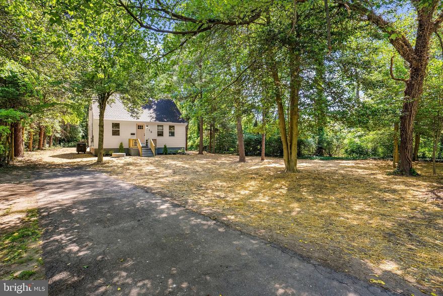 Nestled on an incredible .89-acre wooded homesite, this fully renovated property offers a rare opportunity to own one of the largest residential lots in the area while enjoying modern designer finishes throughout. This home combines move-in-ready living with future possibilities that are hard to find in today’s market. The true standout feature is the expansive, private lot — offering endless potential for a future garage, pool, outdoor entertaining oasis, home expansion, or even a possible ADU/in-law suite opportunity (buyer to confirm land use with Anne Arundel County). Surrounded by mature trees, the property provides a peaceful, tucked-away setting while still being conveniently located near major commuter routes, shopping, and dining. Inside, the home has been completely renovated from top to bottom with a bright open floor plan, custom trim details, and designer finishes throughout. The chef’s kitchen features quartz countertops, stainless steel appliances, a large center island, and flows seamlessly into the main living space highlighted by a custom shiplap electric fireplace. The main level primary suite offers a beautifully finished bath with double vanity, while the upper level features two spacious additional bedrooms. The fully finished lower level adds incredible flexibility with a separate room for an office or 4th bedroom, full bath, private entrance, and large laundry/storage room — ideal for multigenerational living, guests, or a private work-from-home setup. Additional upgrades include a new roof, new HVAC system, new siding, and new windows for peace of mind. Outside, enjoy a covered back porch perfect for entertaining along with abundant off-street parking. Properties with this much usable land, privacy, and renovation quality rarely become available — a truly unique opportunity in Glen Burnie.